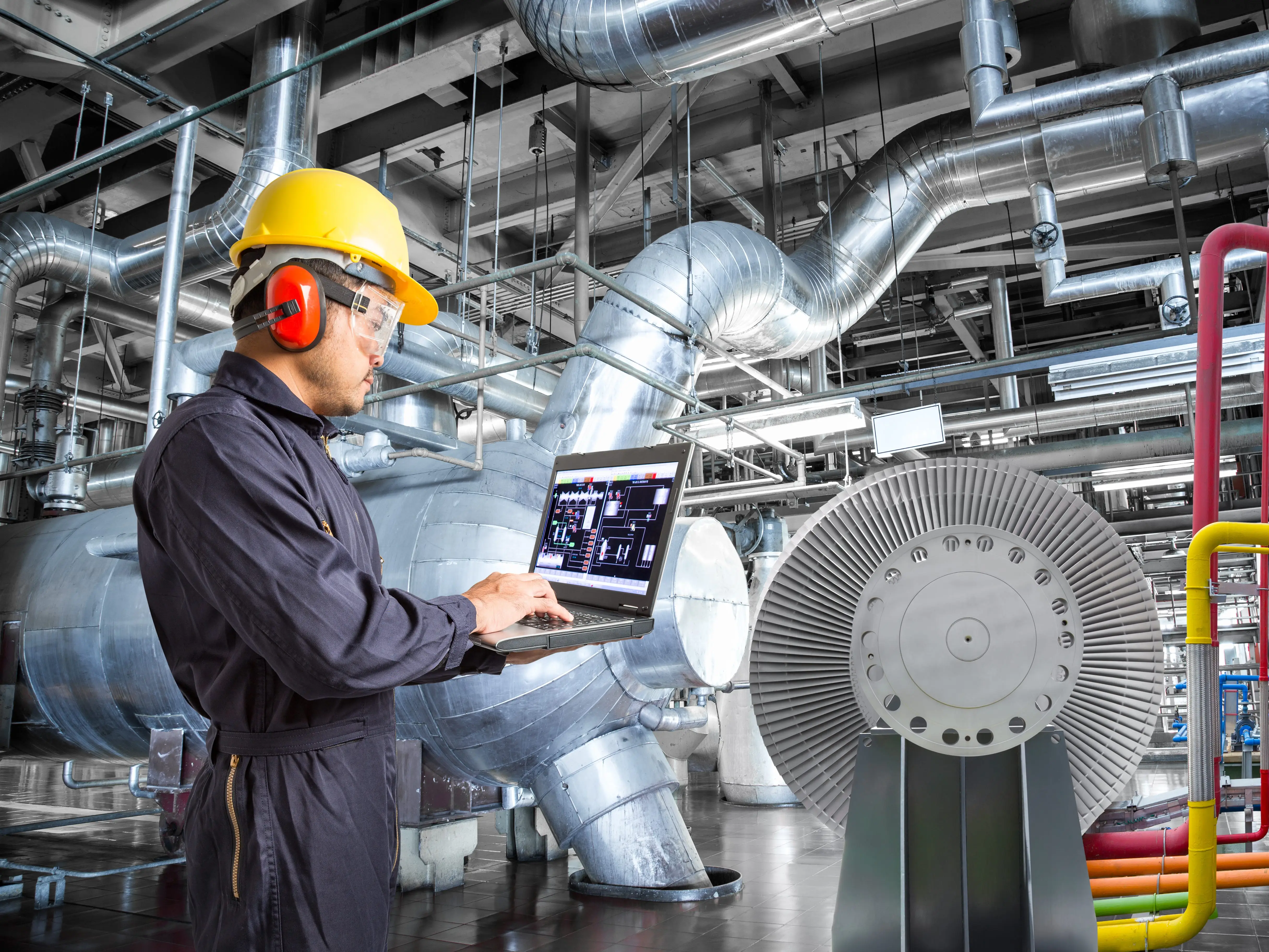 A worker holding a laptop