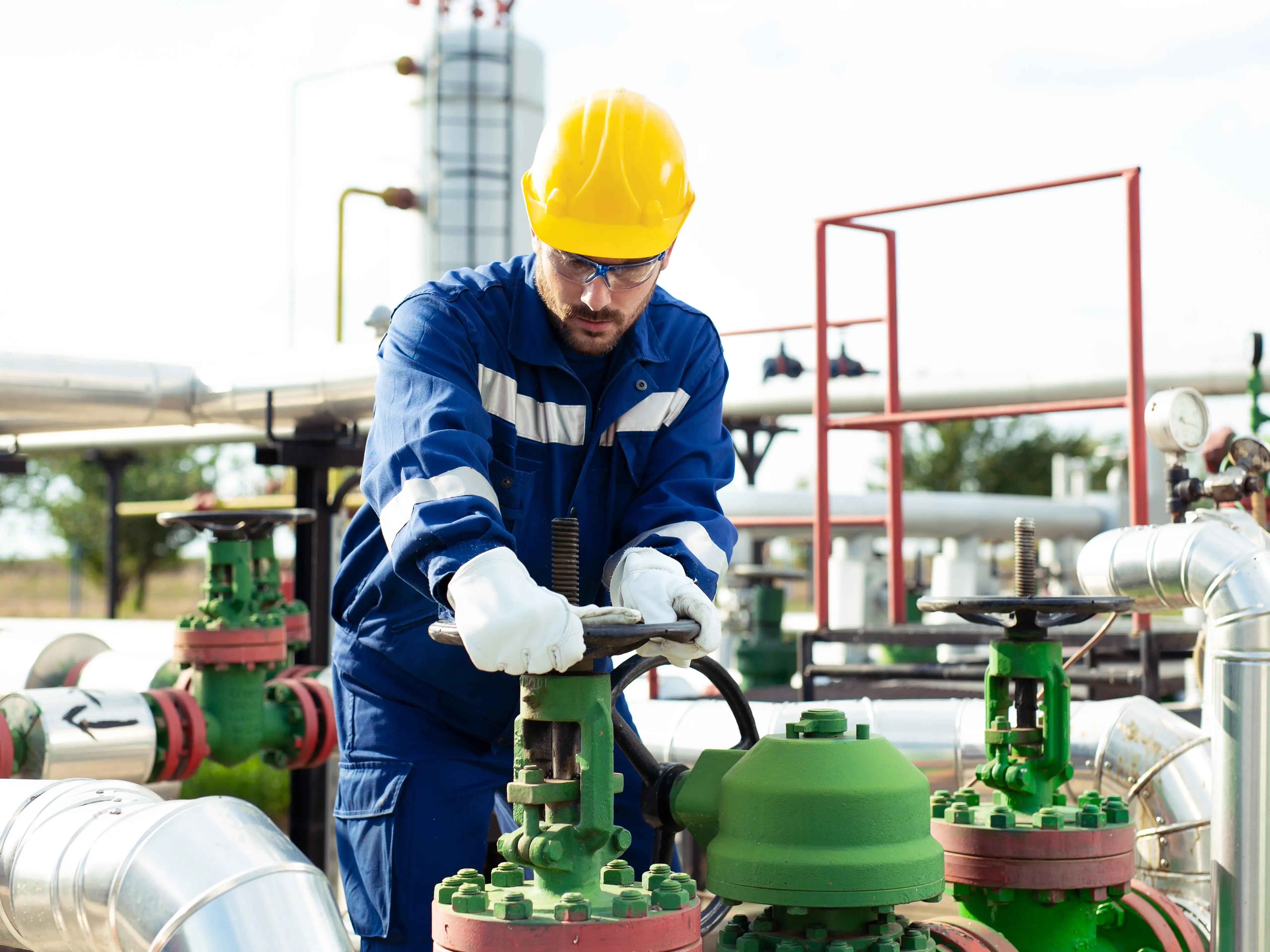 Worker with refinery equipment