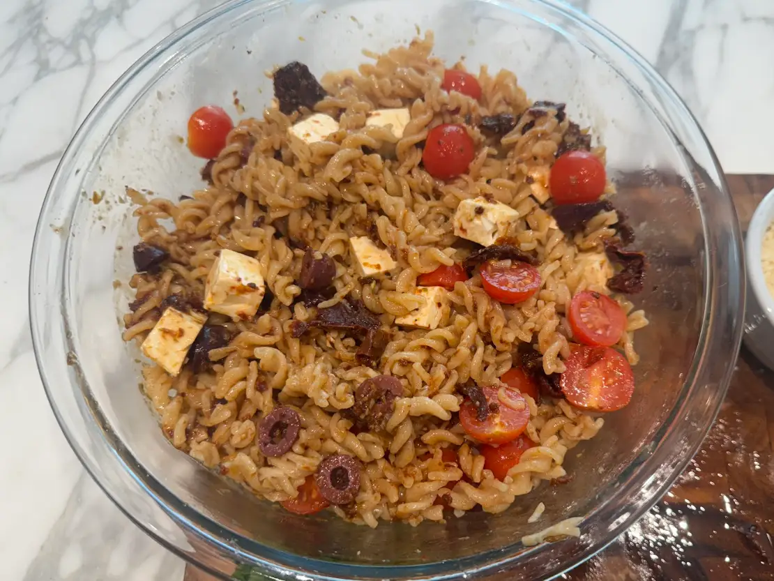Ina Garten's pasta salad in a bowl on the kitchen table.