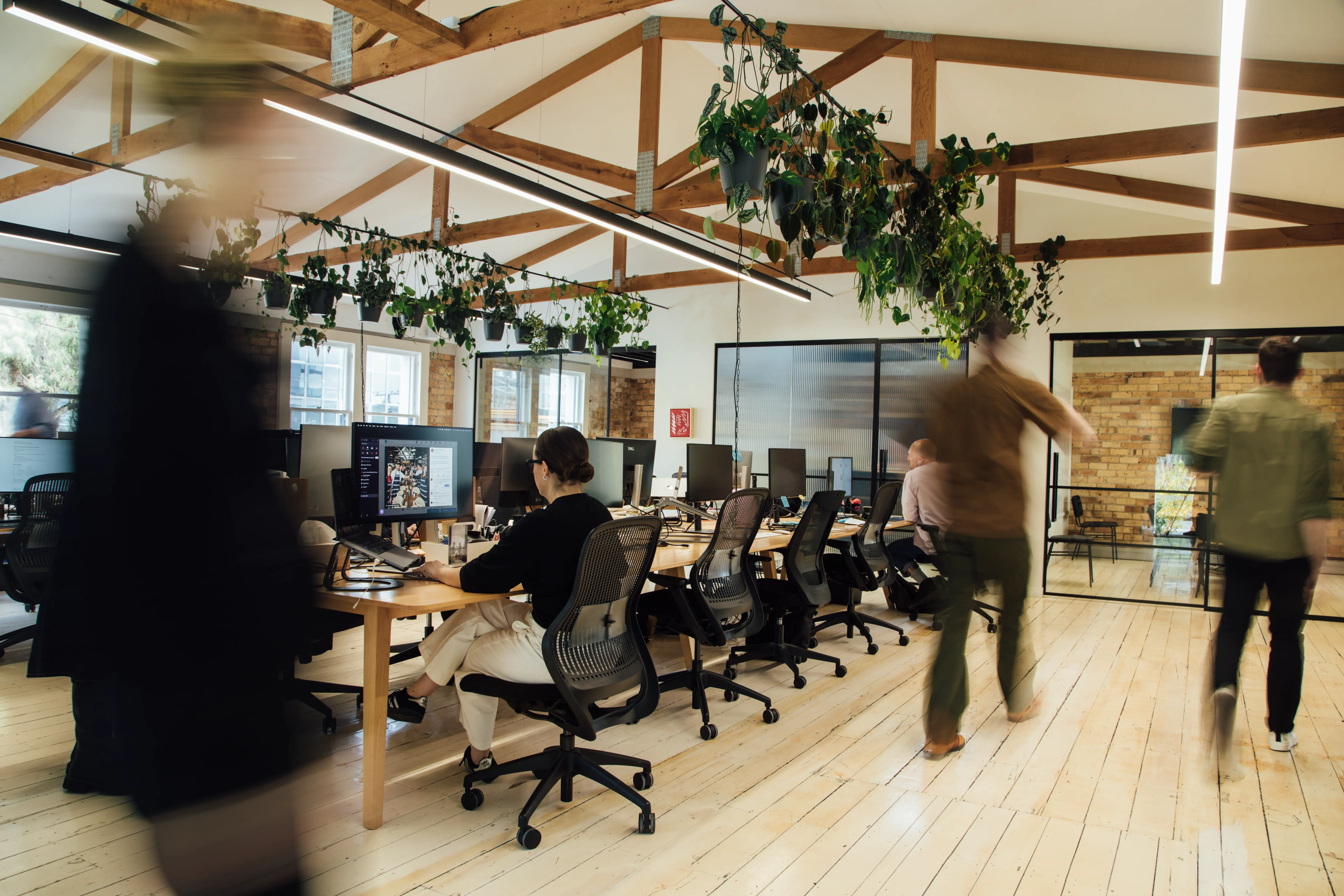 A worker walks past colleagues at Previously Unavailable's office space.