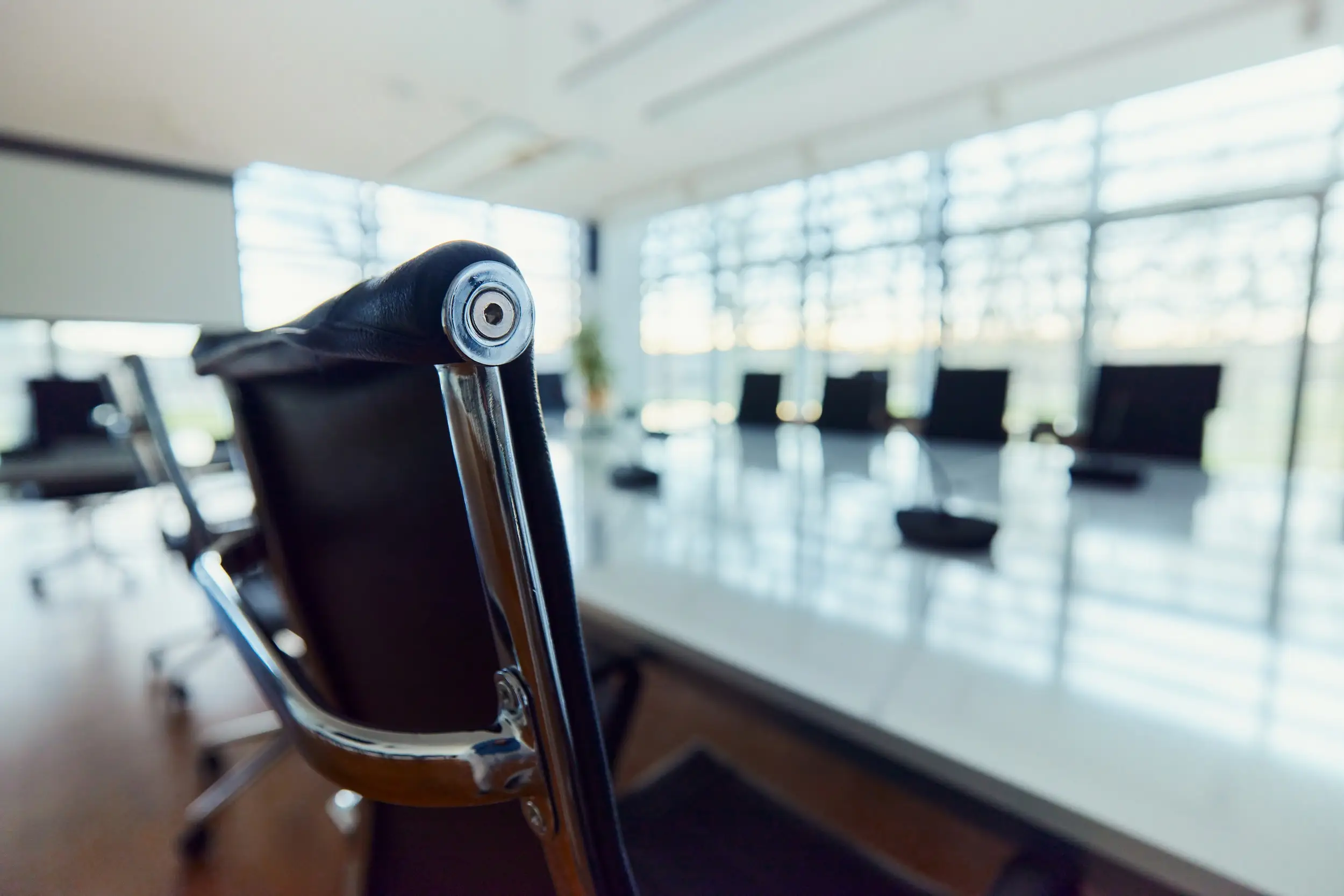 A stock photo of an empty boardroom with an office chair.
