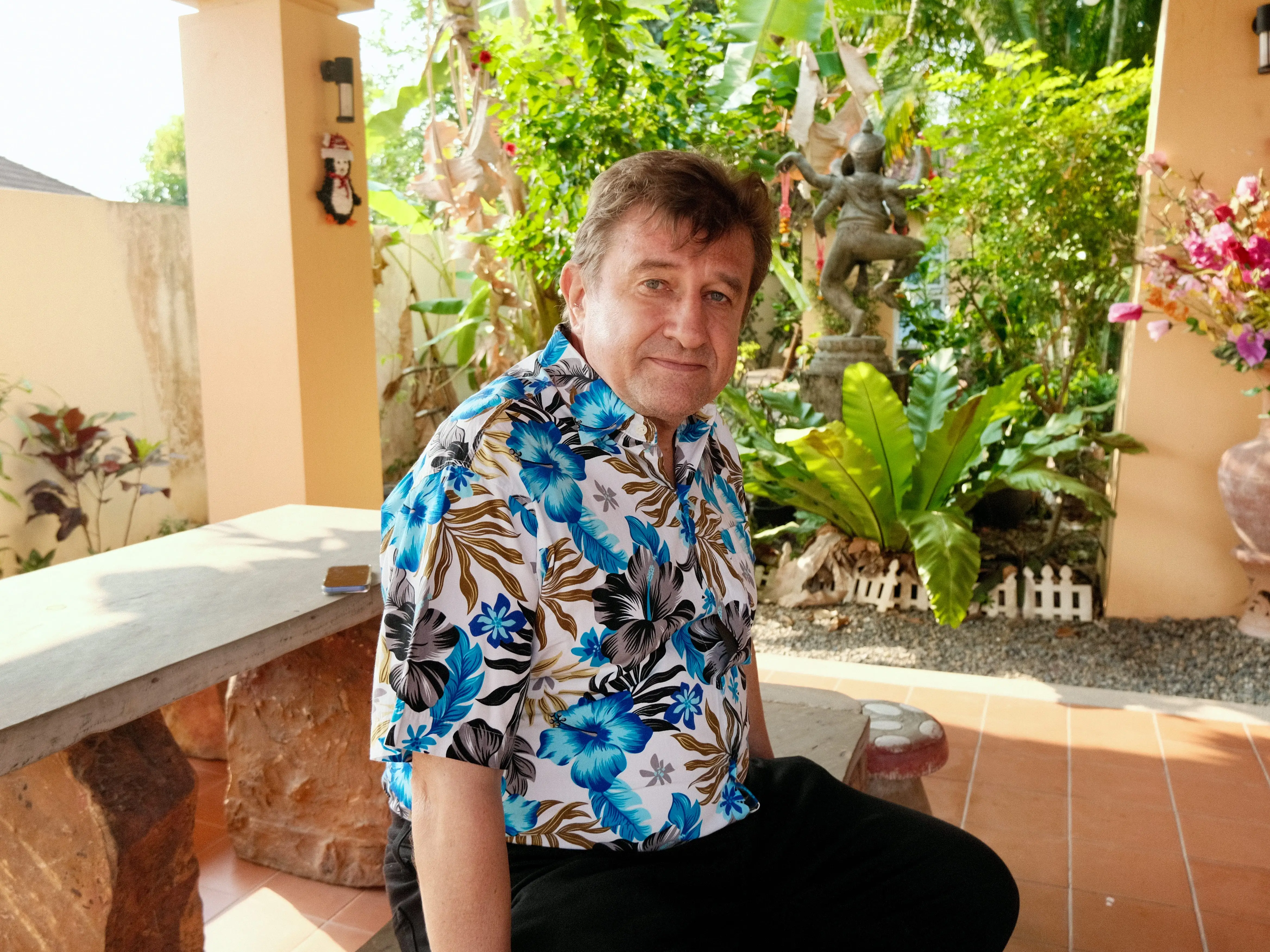 A man posing on a bench.