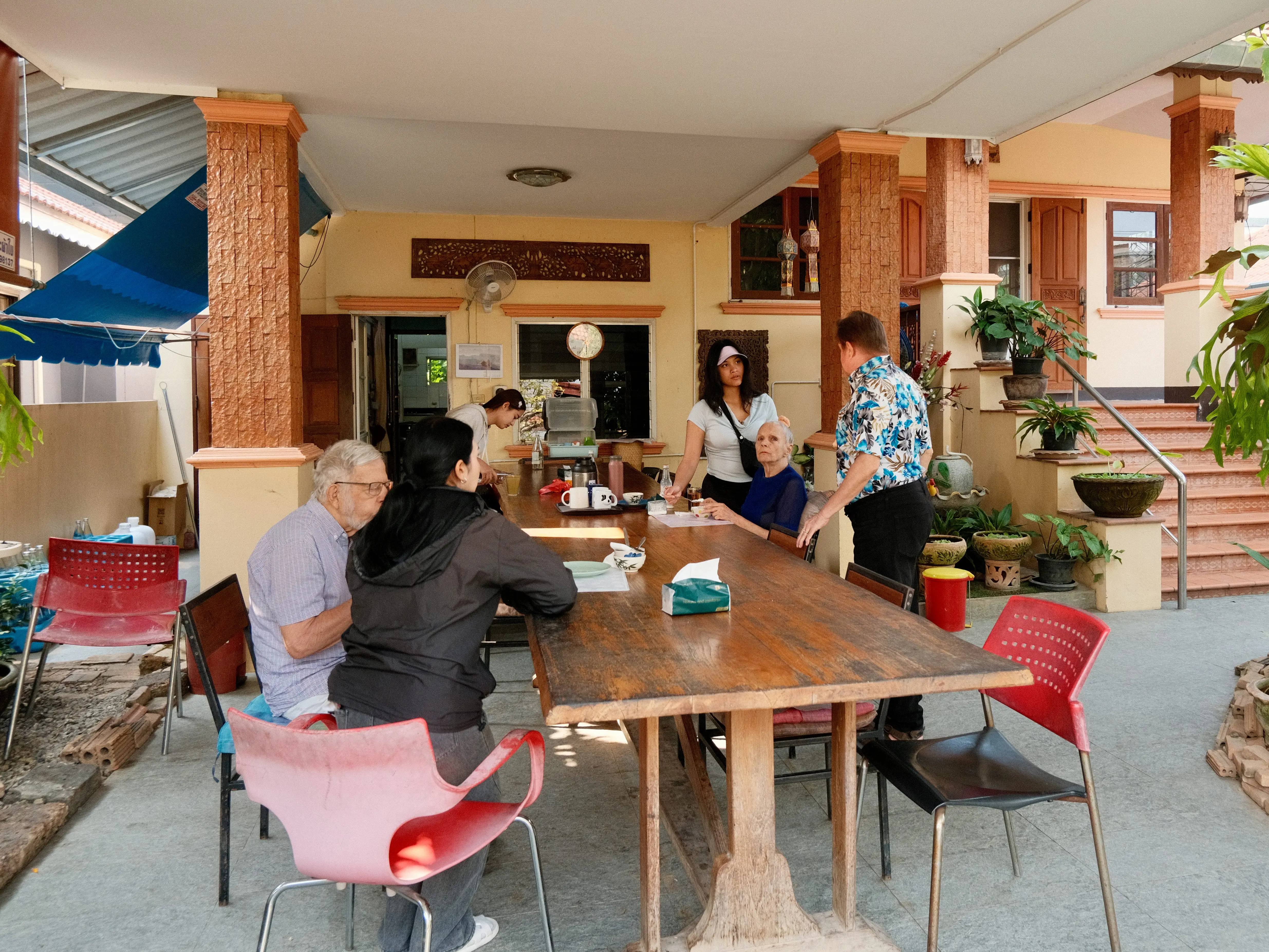 A man interacting with caretakers and people who have dementia.