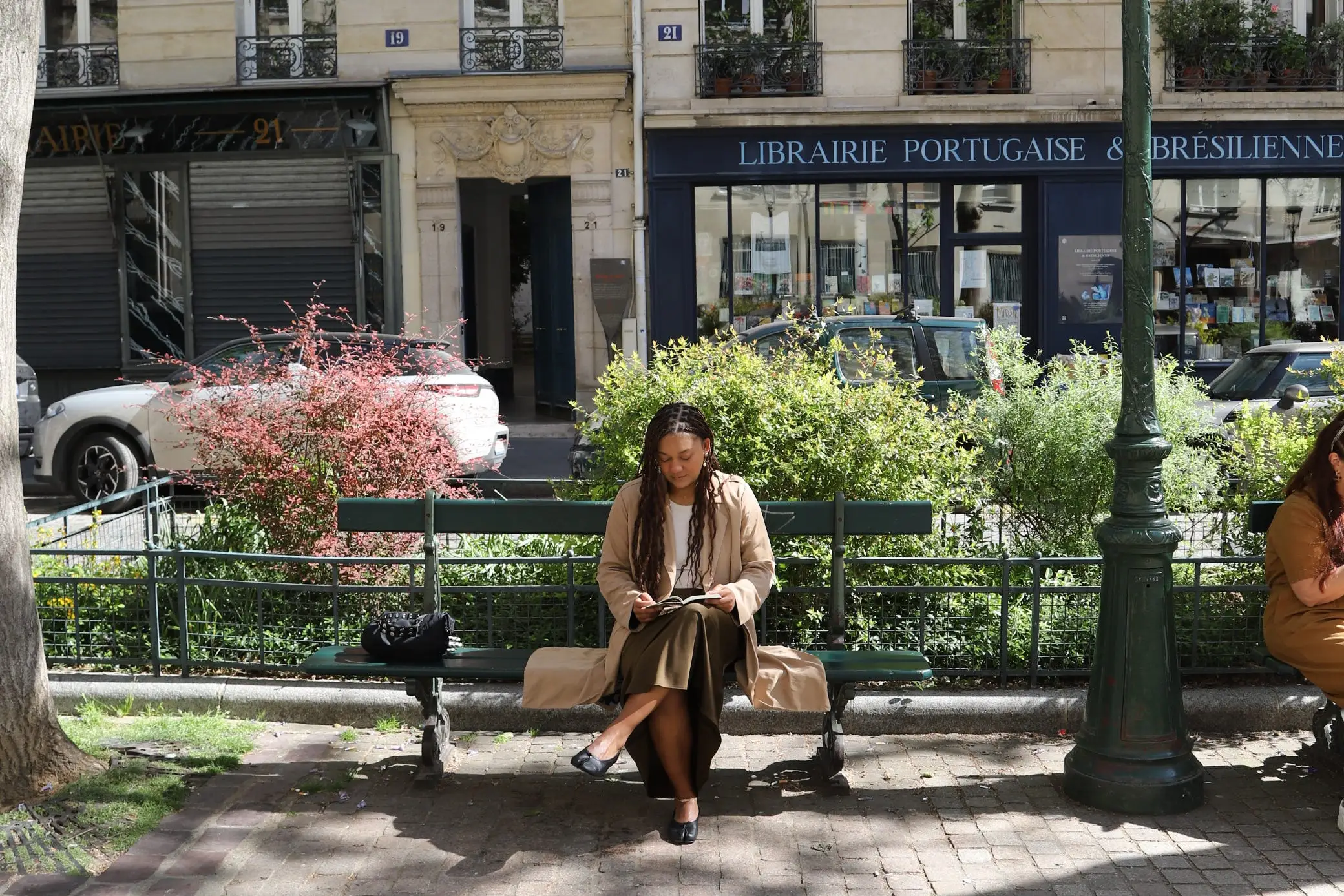 Author Naydeline Mejia sitting on bench looking down