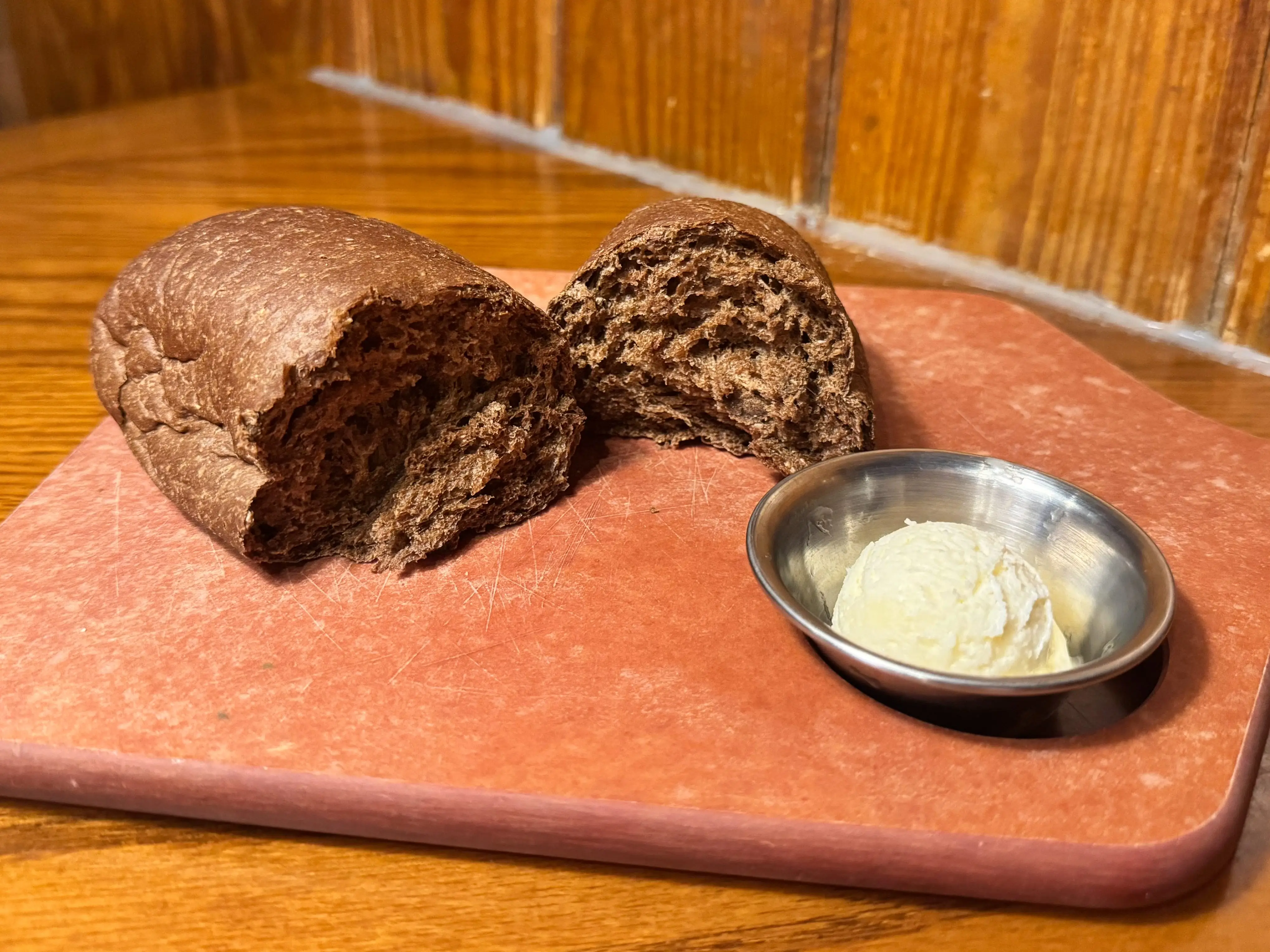 Bread and butter on a cutting board.