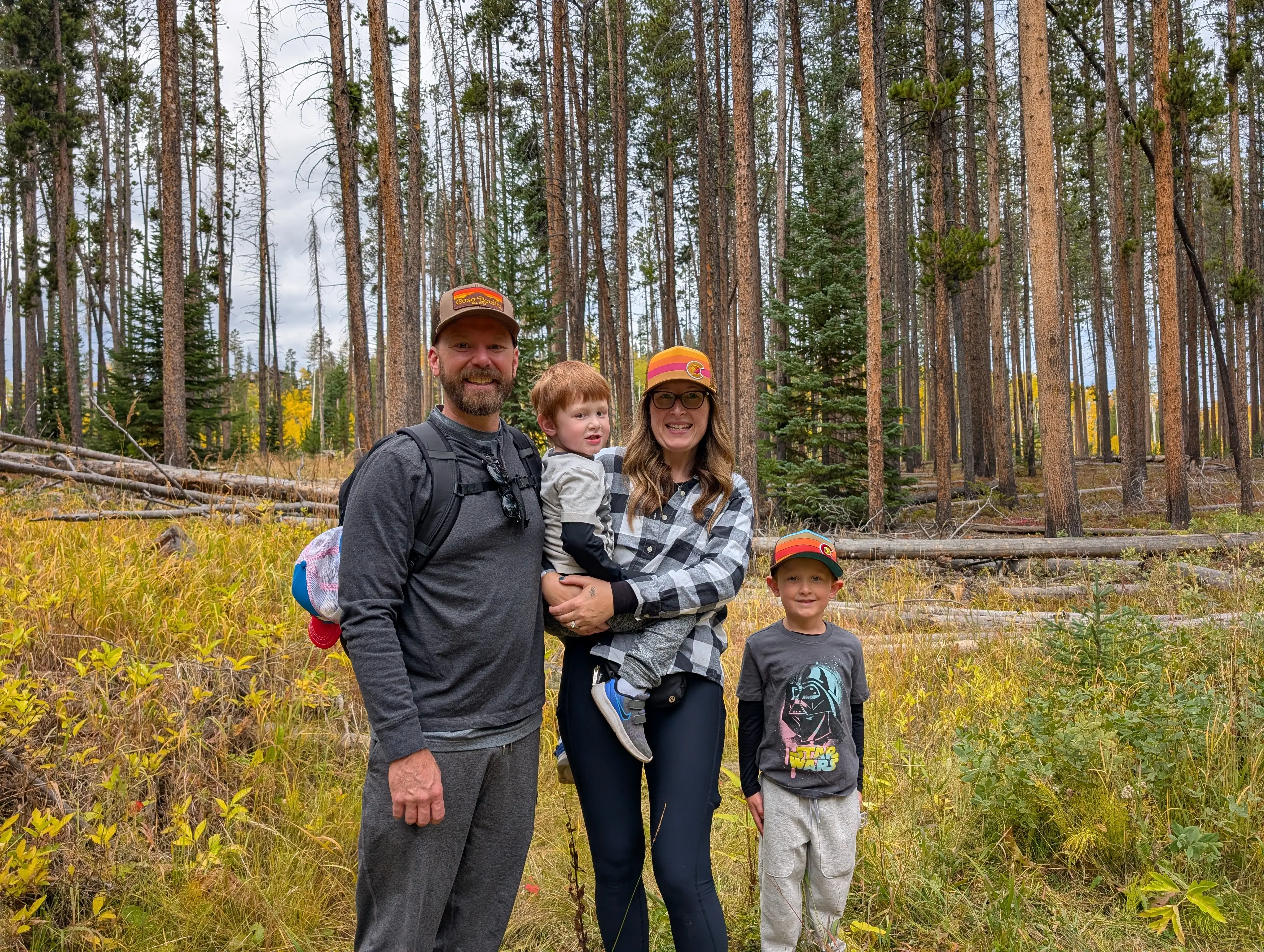 Family of four smiling on hike in Colorado