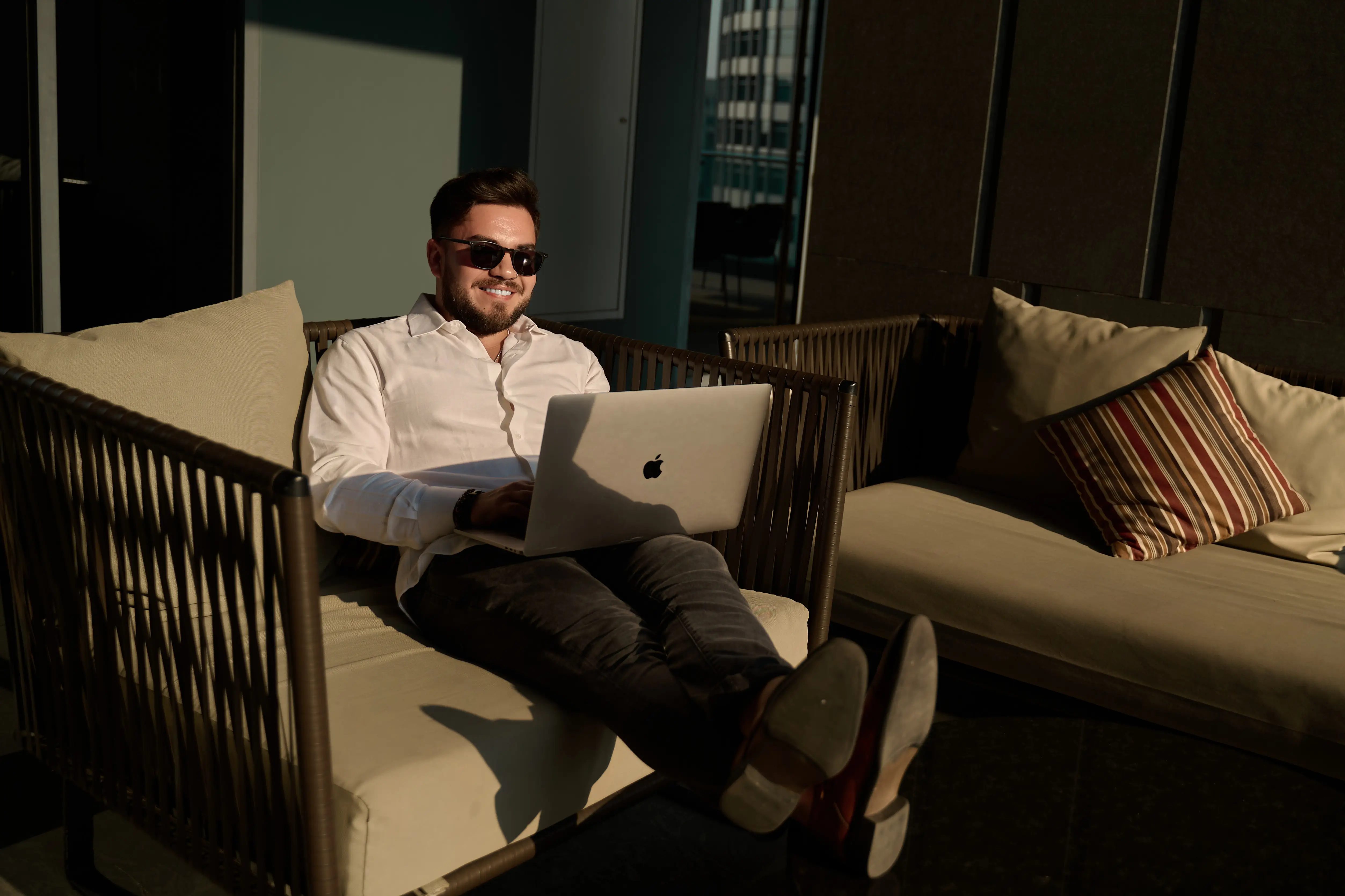 A man working on his laptop at his condo.