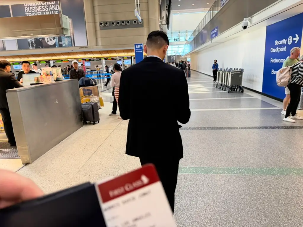 Back of man in suit in airport