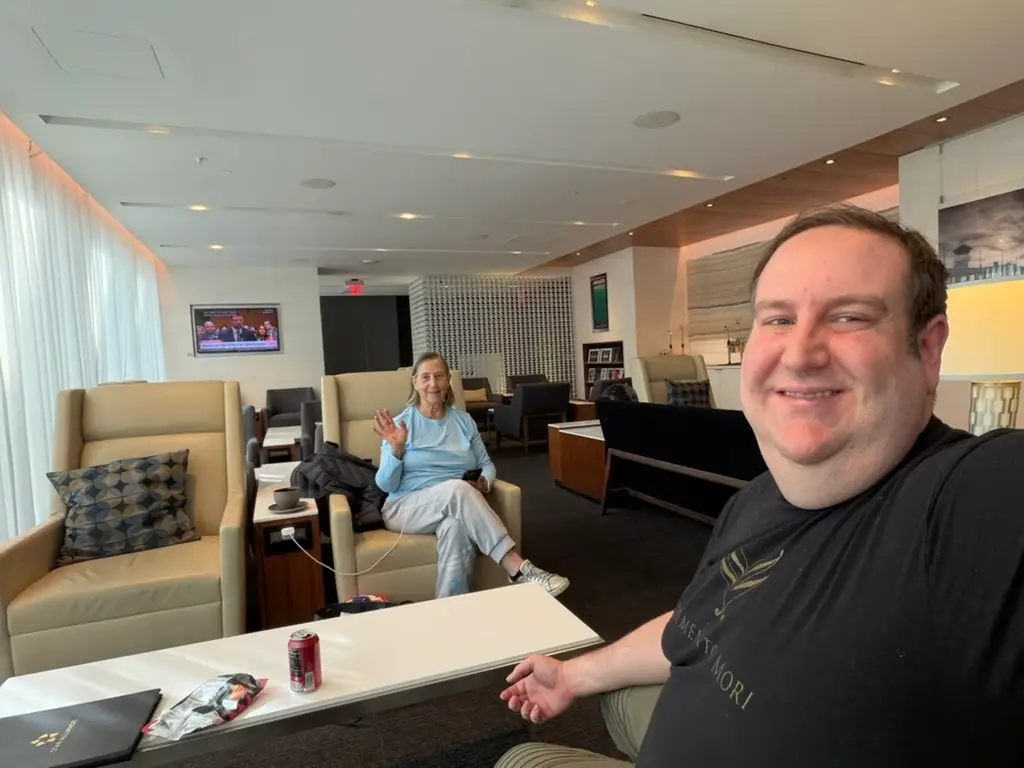 Man sitting at table with woman at airport