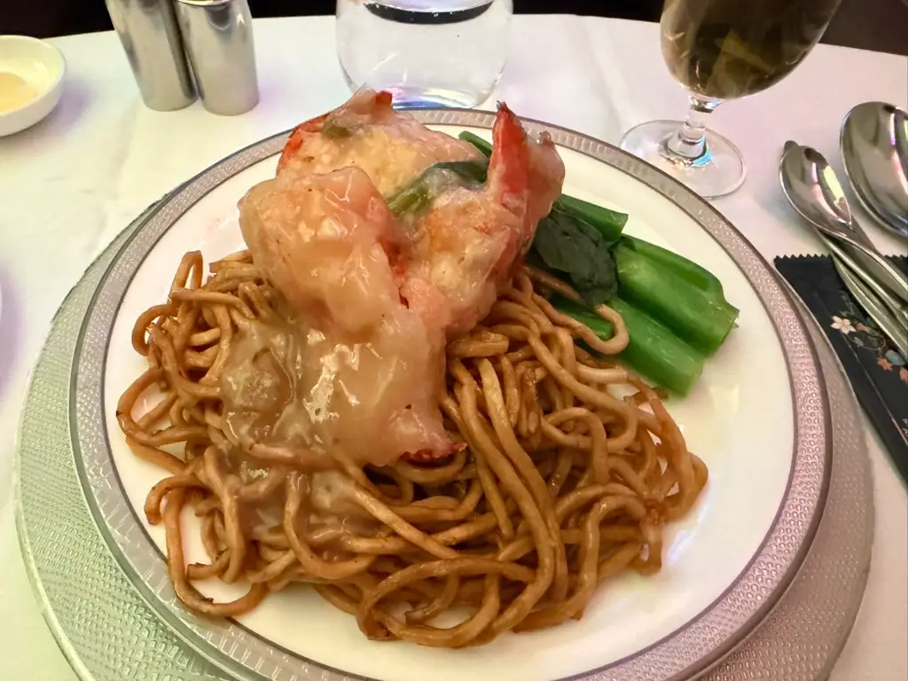 Plate of noodles topped with seafood