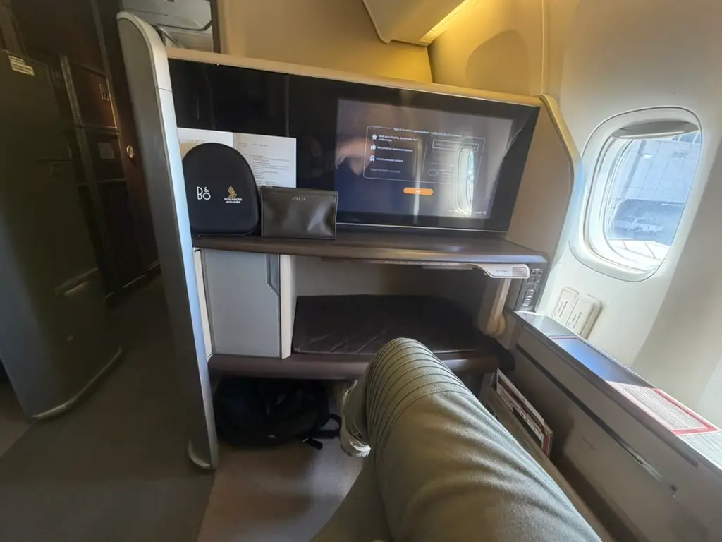 Screen, storage, view of legroom on Singapore Airlines first-class seat