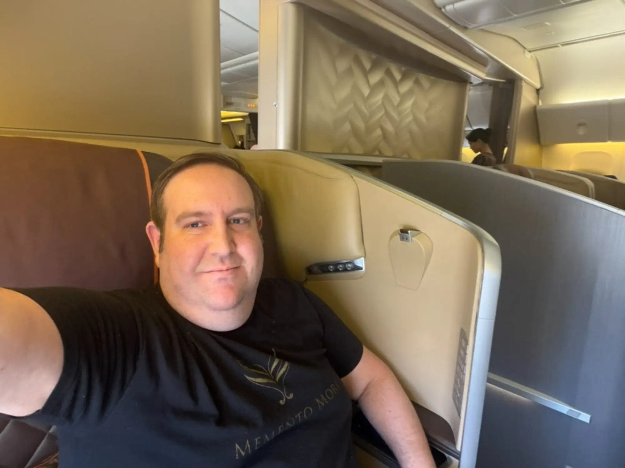 Man taking selfie in first-class seat on Singapore Airlines flight