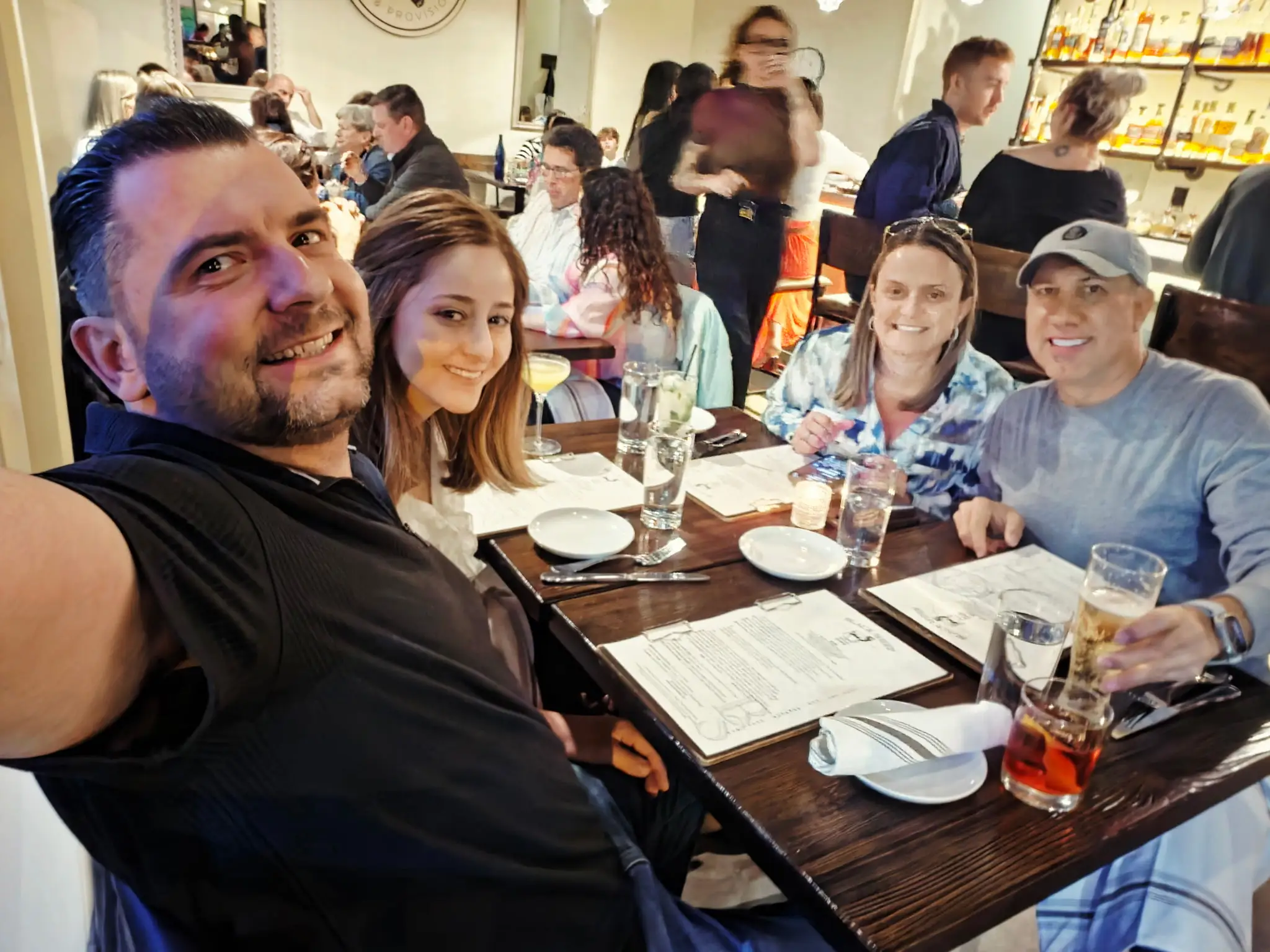 Group of people sitting around dinner table in NYC