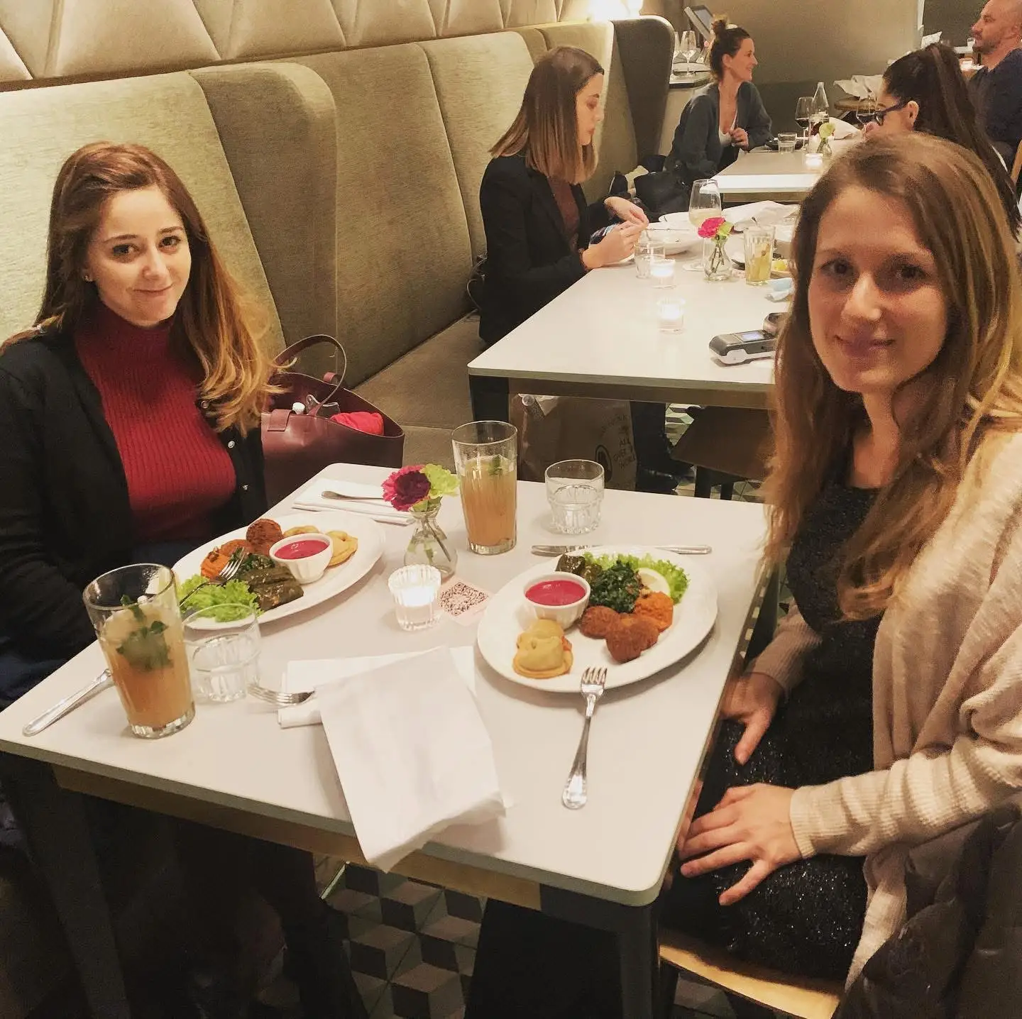 Two women sitting at dinner table at restaurant in Switzerland