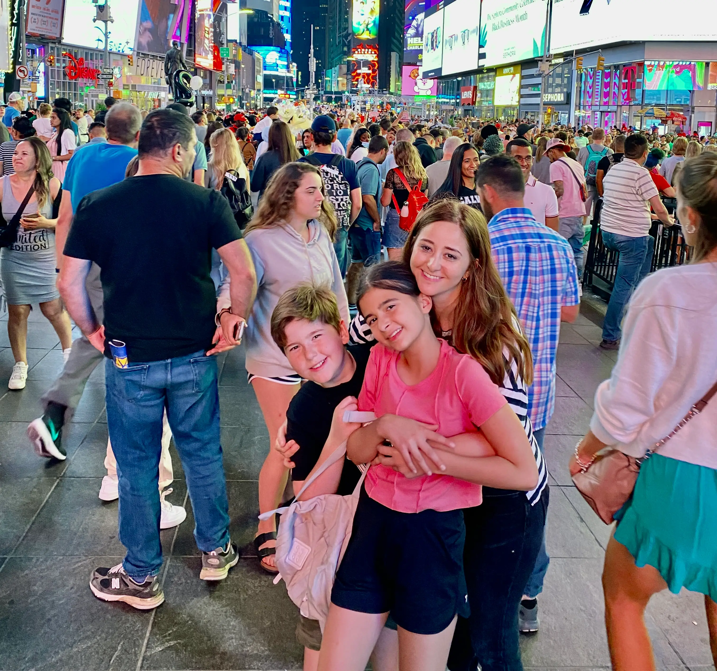 Family smiling in Times Square