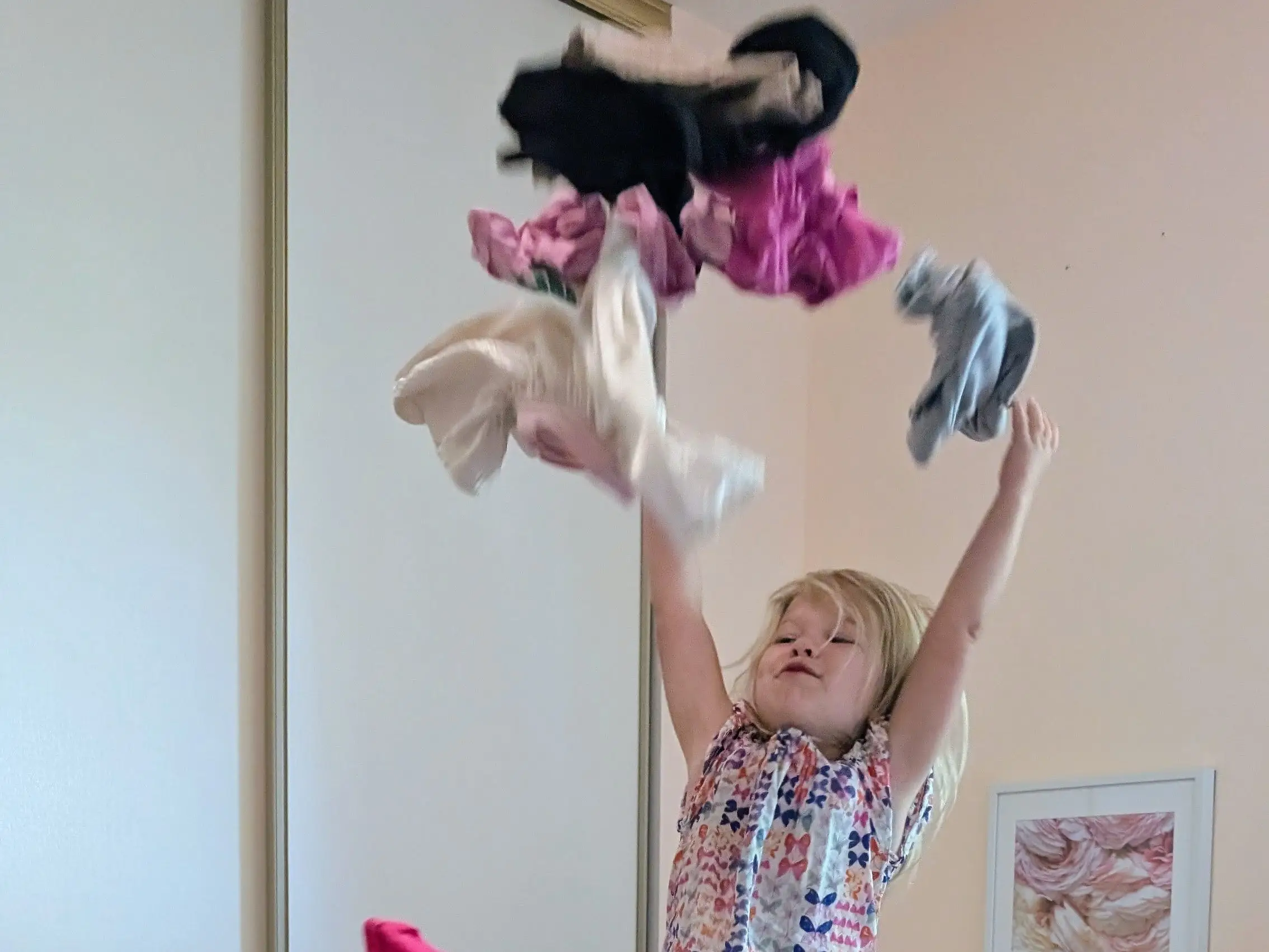 Girl throwing clothes in the air