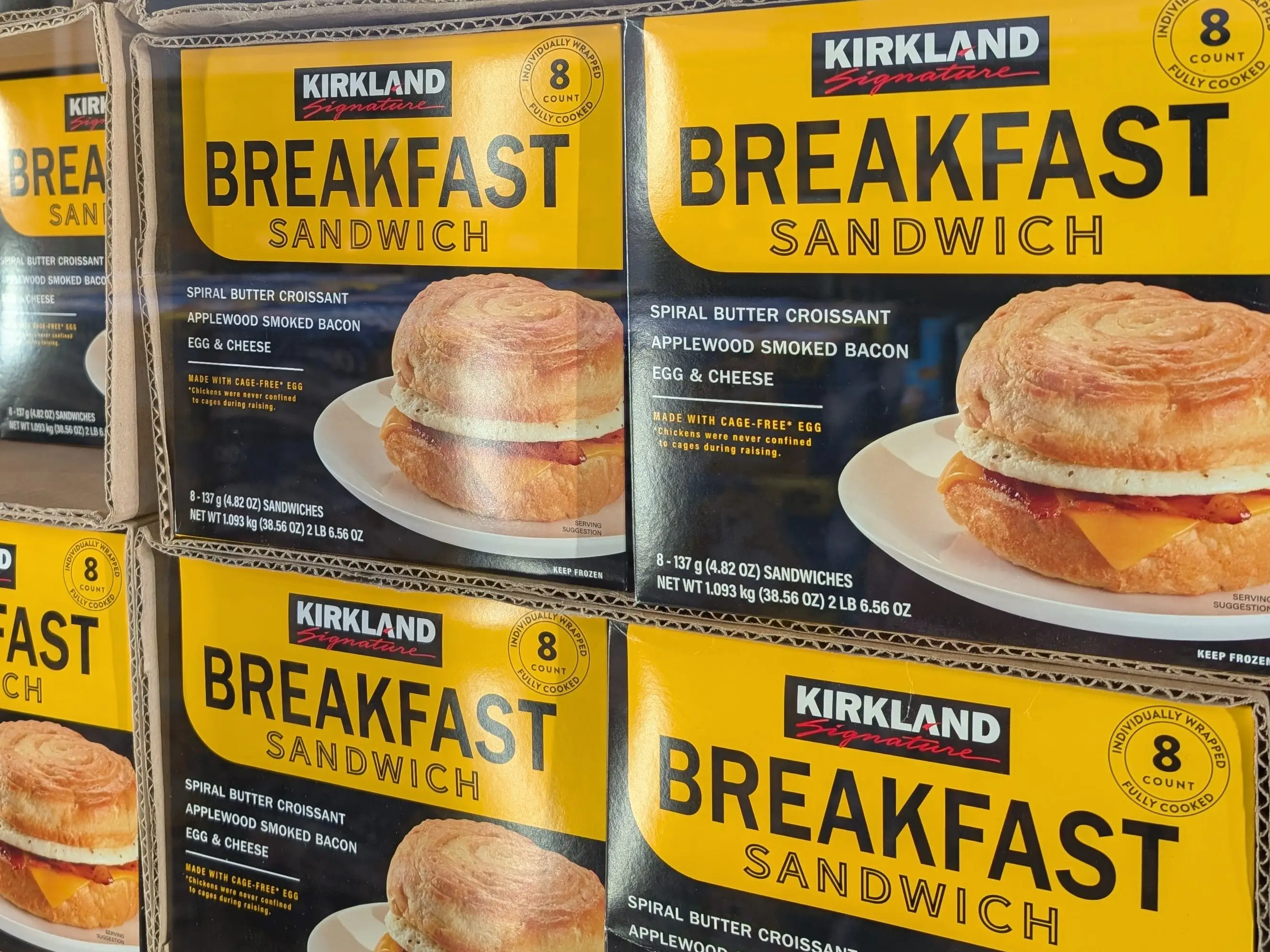 Several boxes of Kirland Signature breakfast sandwiches.