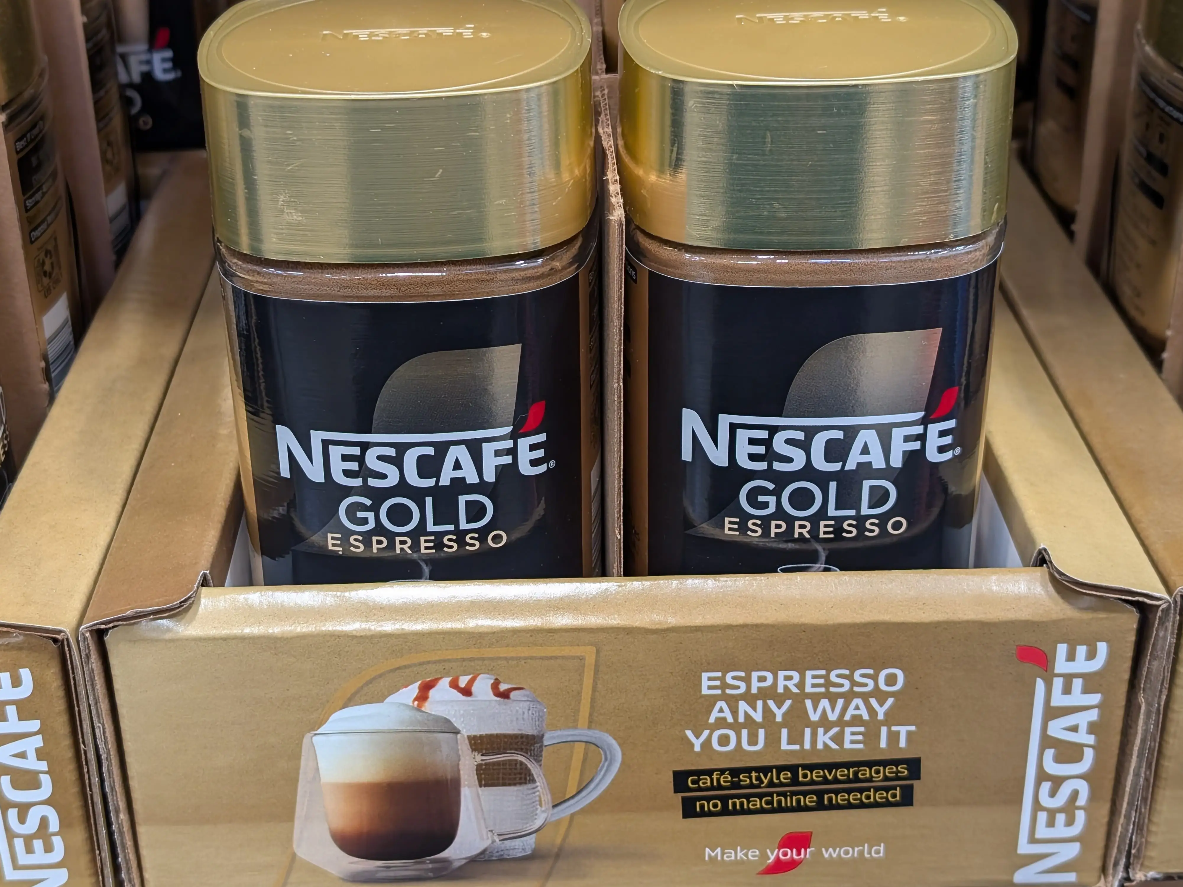 Two containers of Nescafé Gold instant espresso.