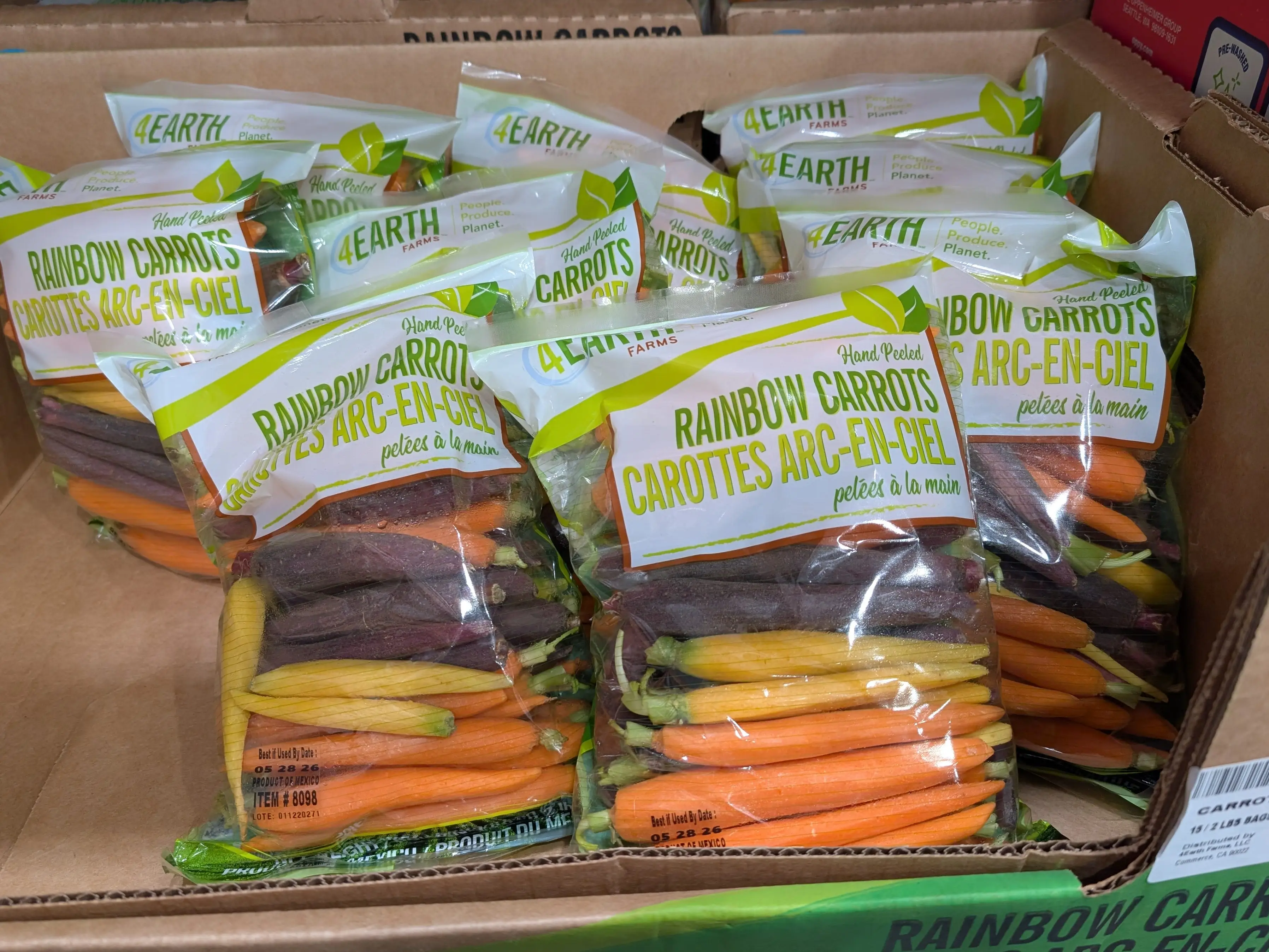 Several bags of 4Earth Farms rainbow carrots.