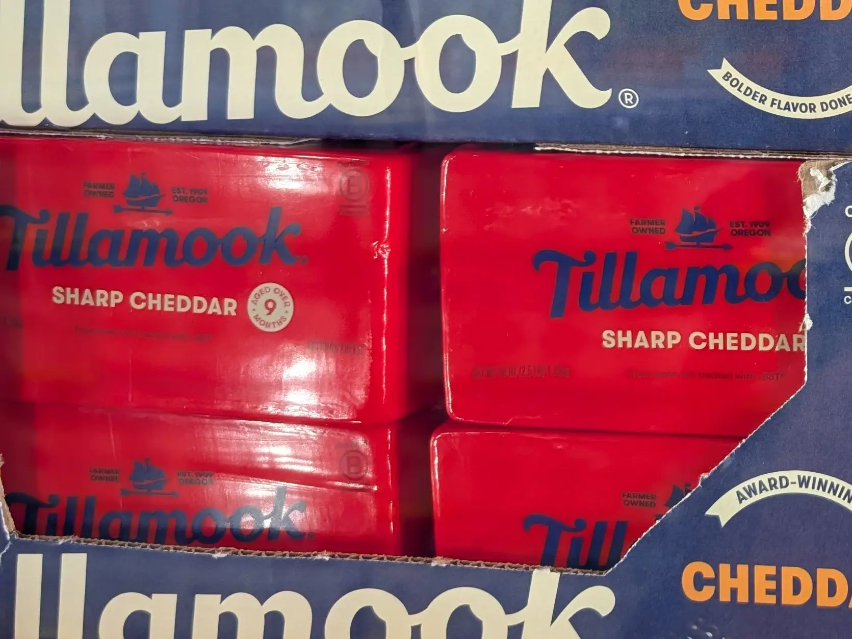 Multiple blocks of Tillamook sharp cheddar cheese.