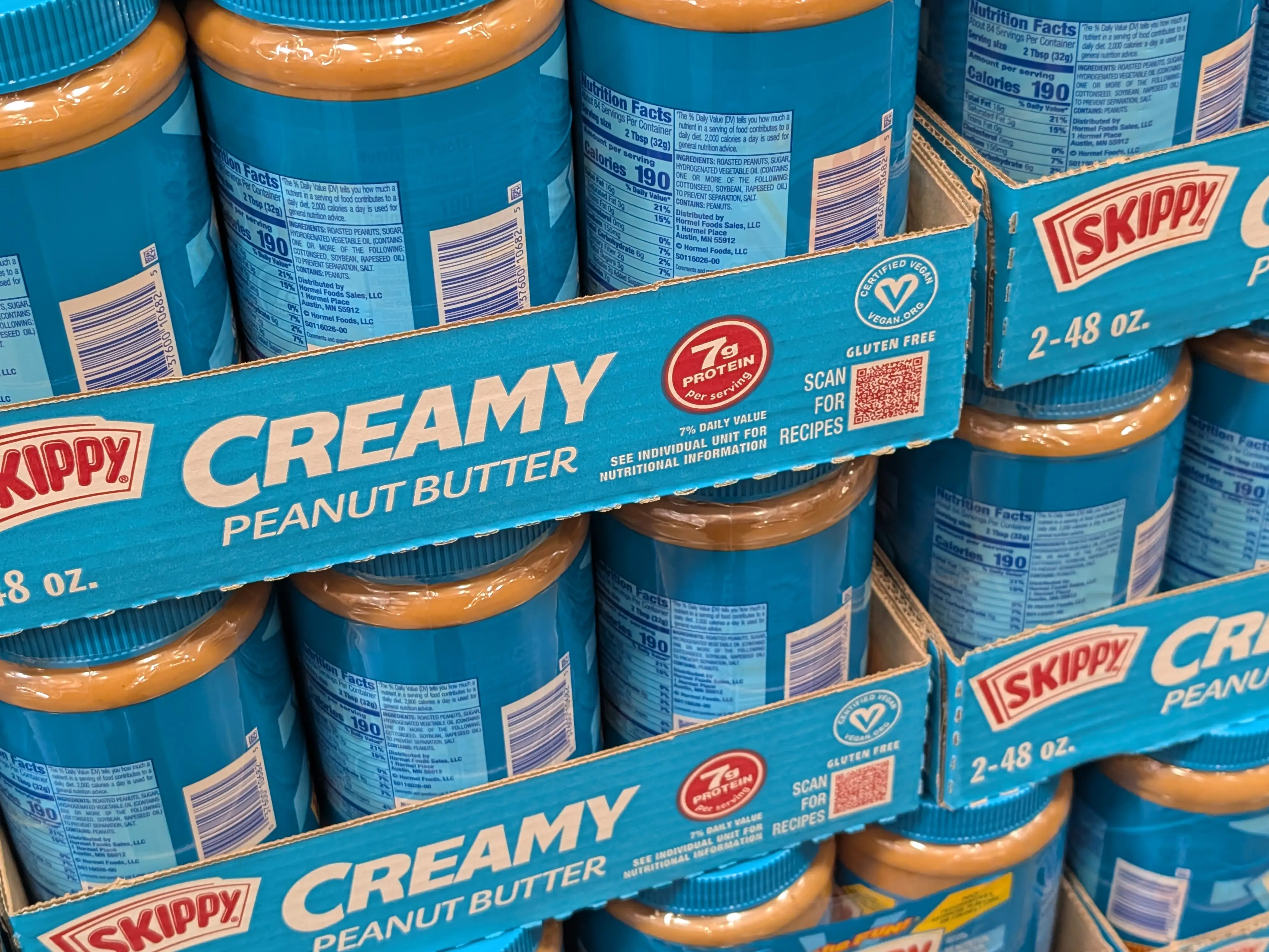 Multiple jars of Skippy creamy peanut butter.