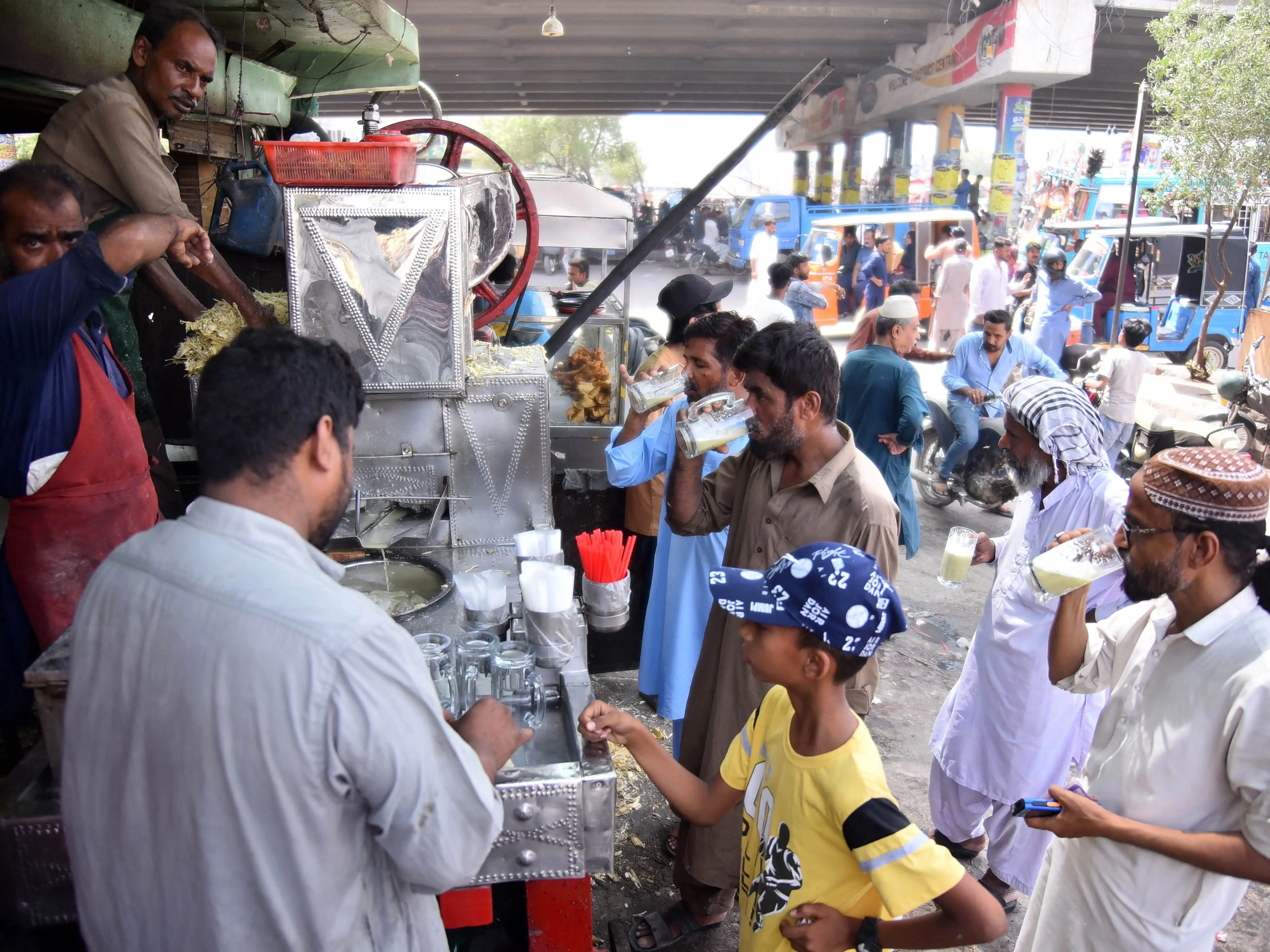 Residents in Karachi, Pakistan, drink sugarcane juice during a heatwave.