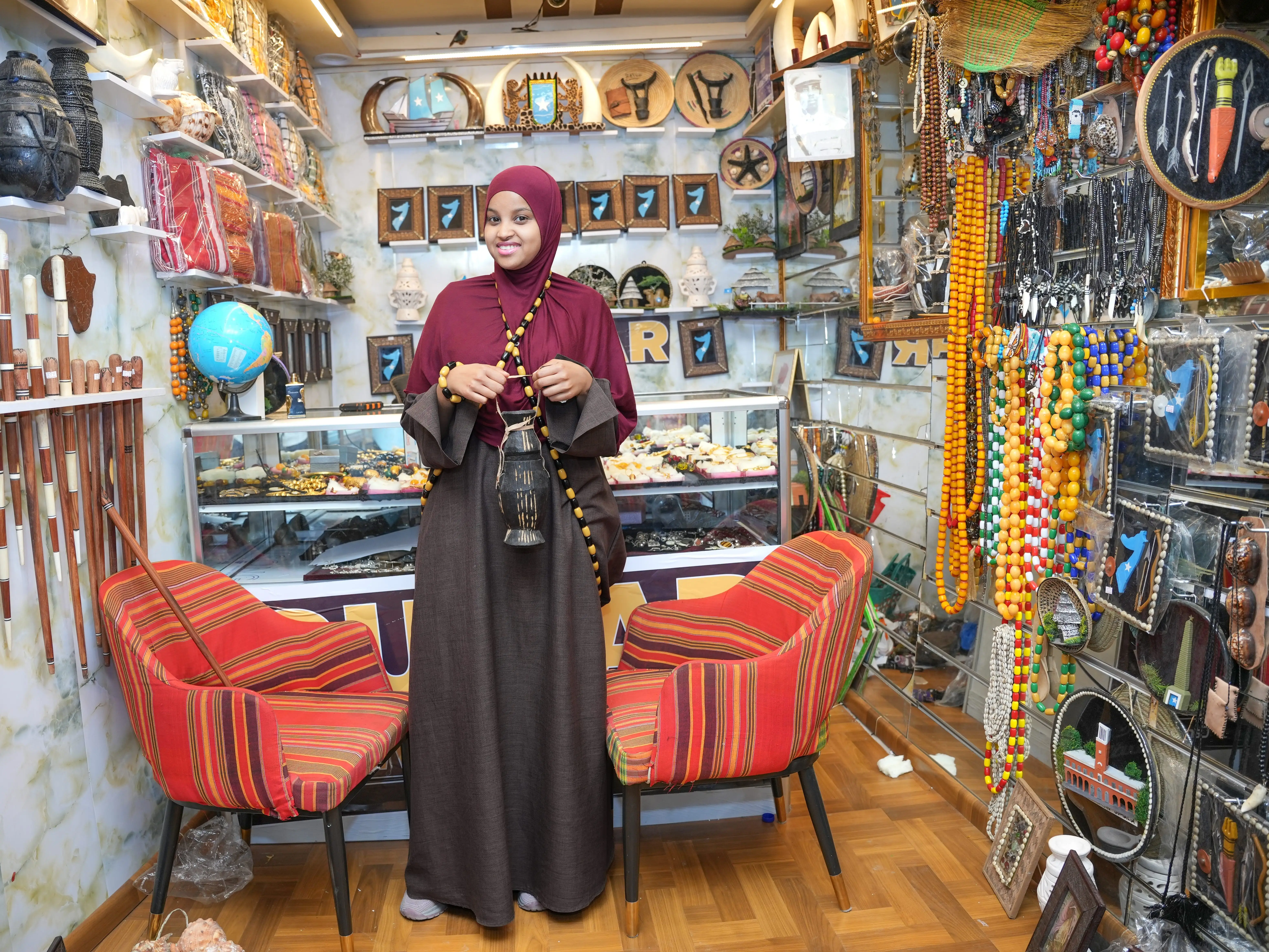 A woman stands in an artisan shop in Mogadishu, Somalia.