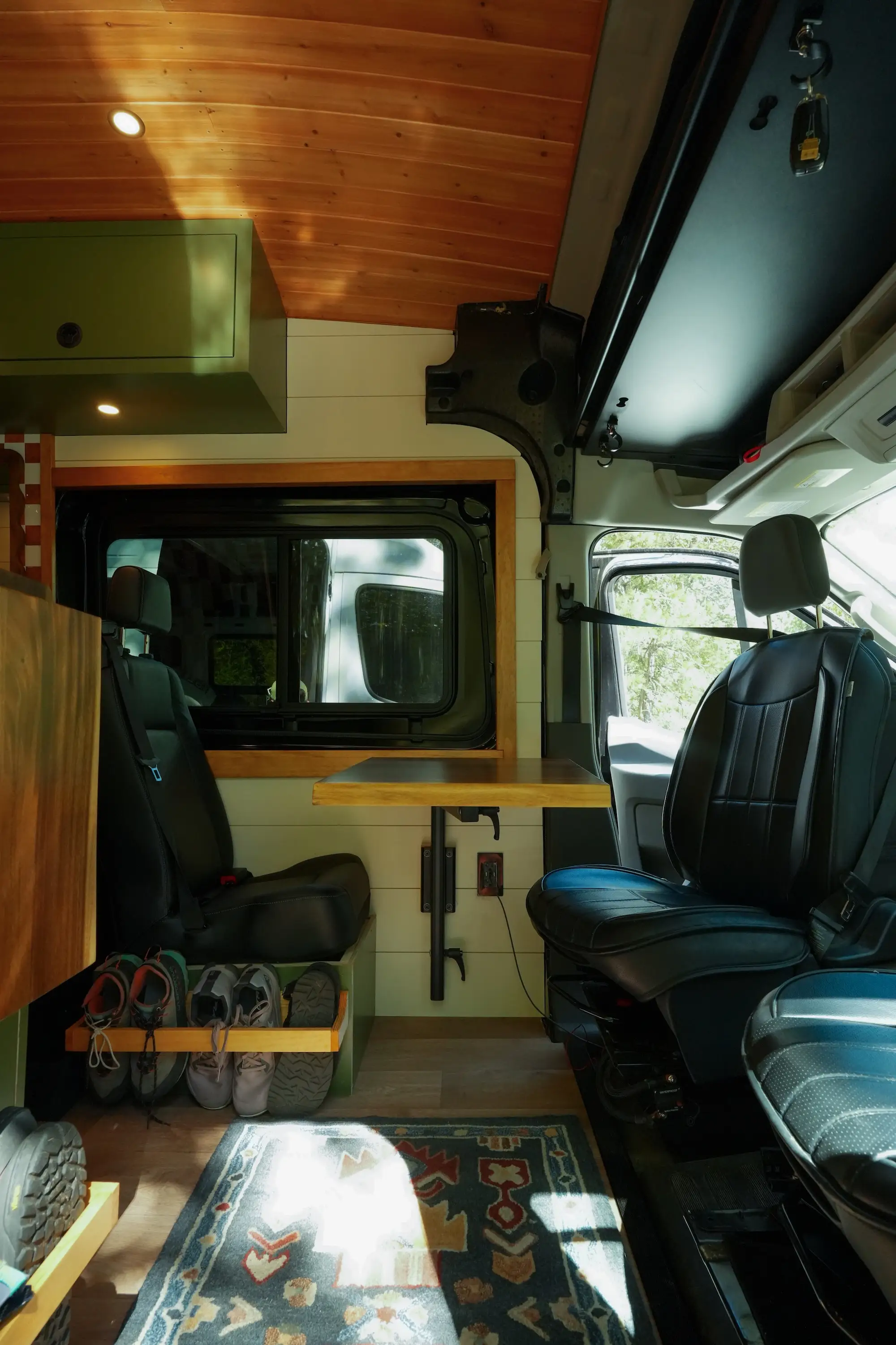 The front of a van, showing three black seats that swivel.