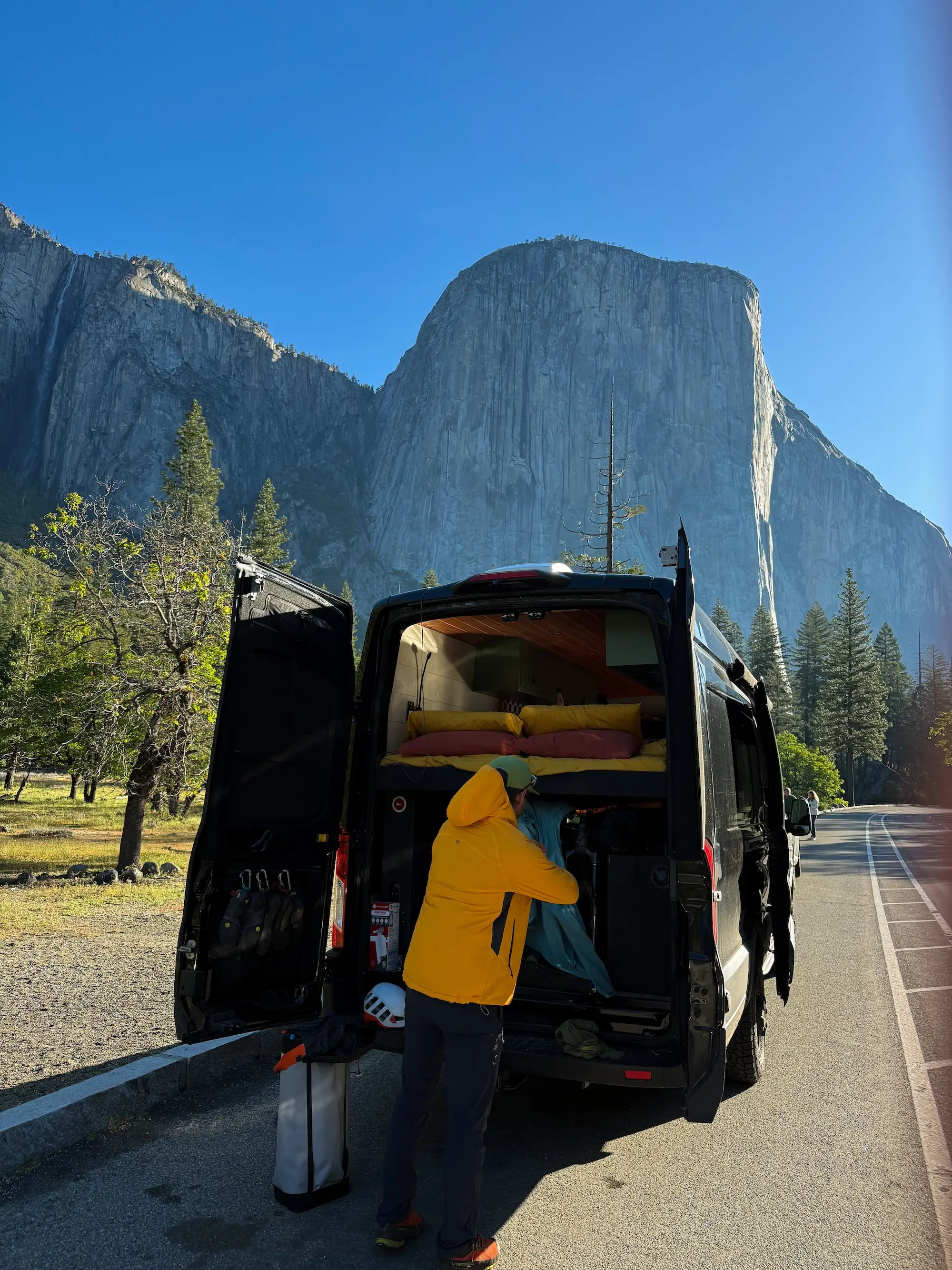 A man loads gear into a van in Yosemite National Park.
