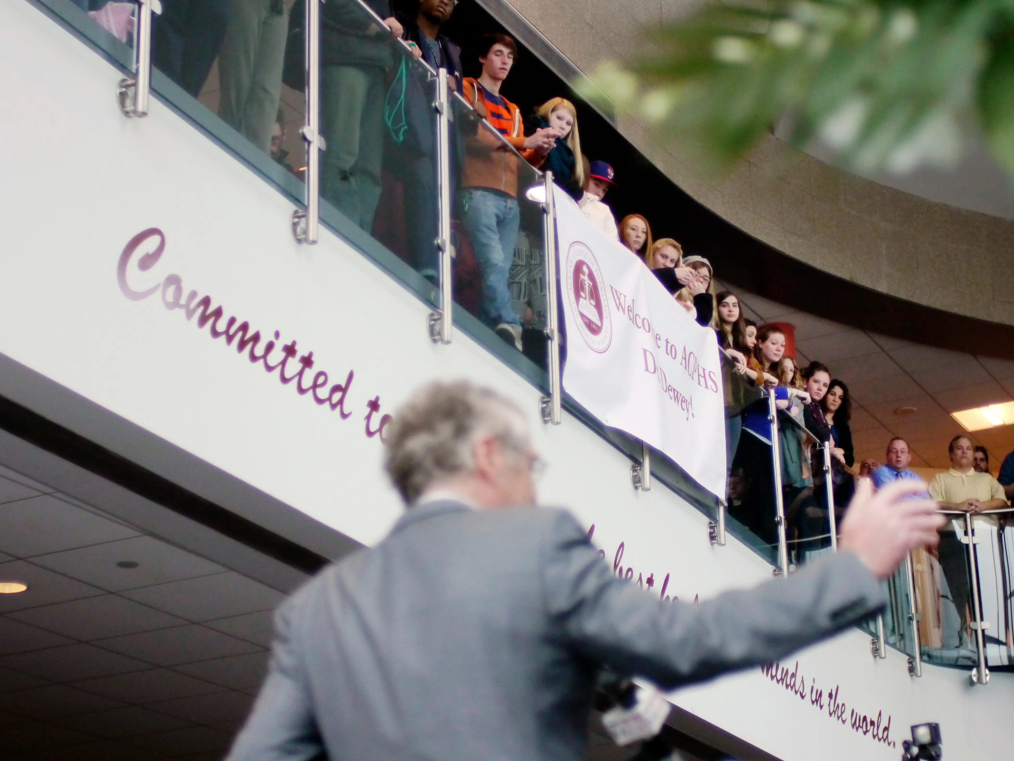 Students listen from a balcony as Greg Dewey, foreground, the new president of Albany College of Pharmacy and Health Sciences, addresses those gathered at an event in the Student Union where Dewey and his wife Cindy were introduced to students and staff on Tuesday, Dec. 3, 2013 in Albany, NY.