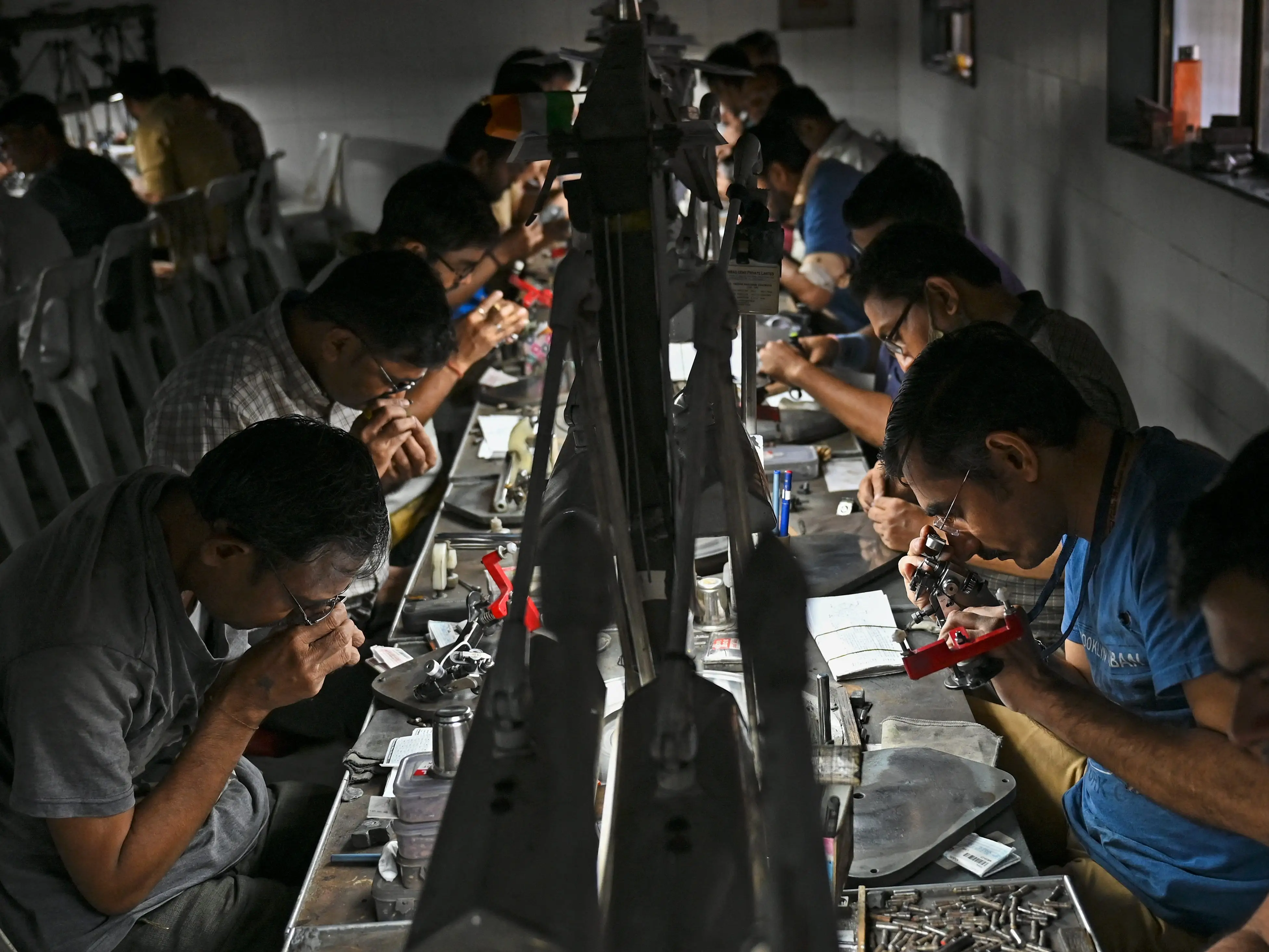 Workers examine diamonds in Surat, India.