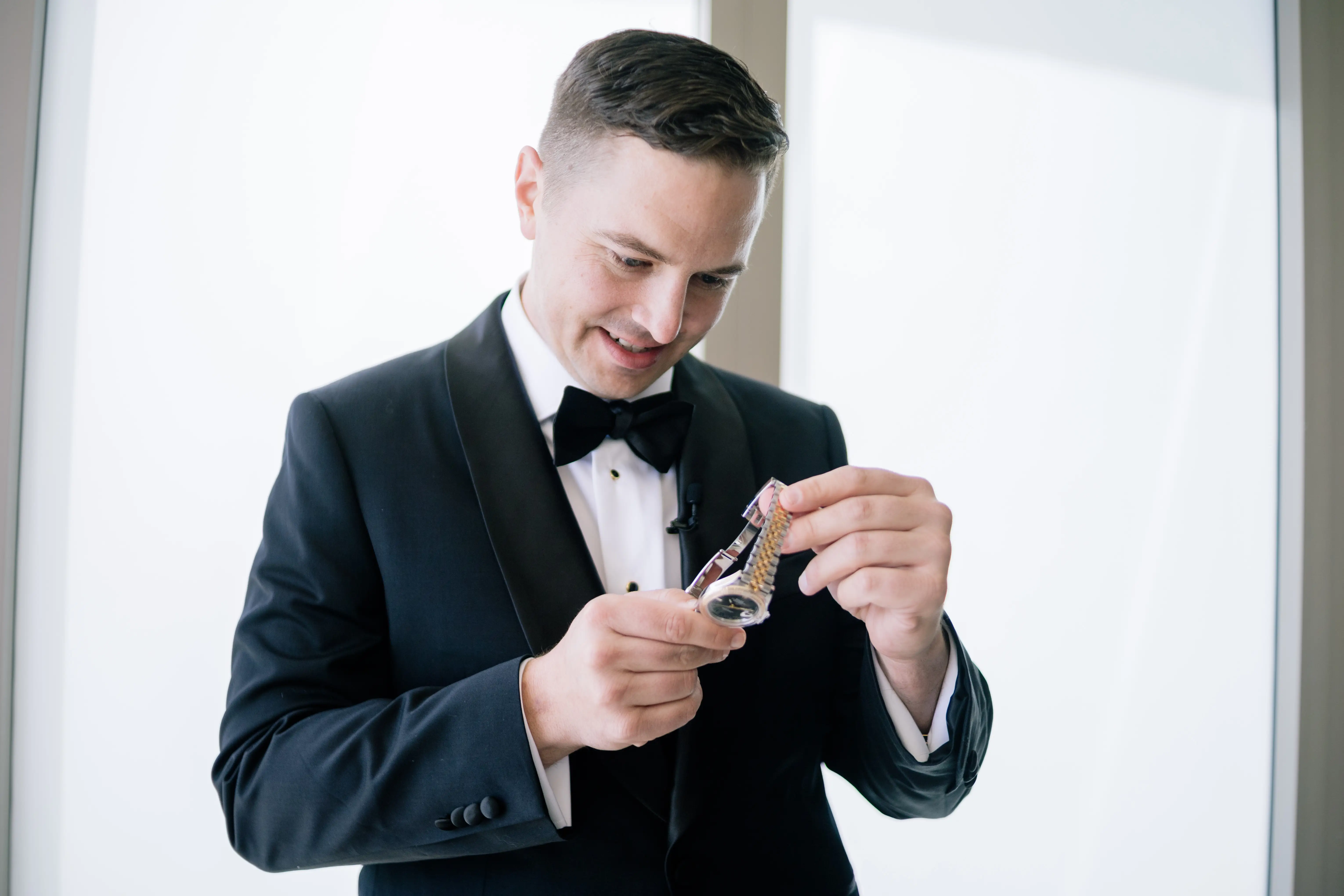 Christopher Kopinski looks at his Rolex.