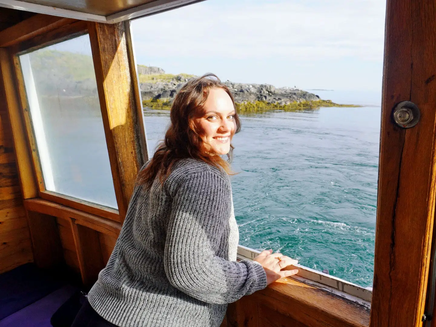 Emy poses near the window of an old ferry.