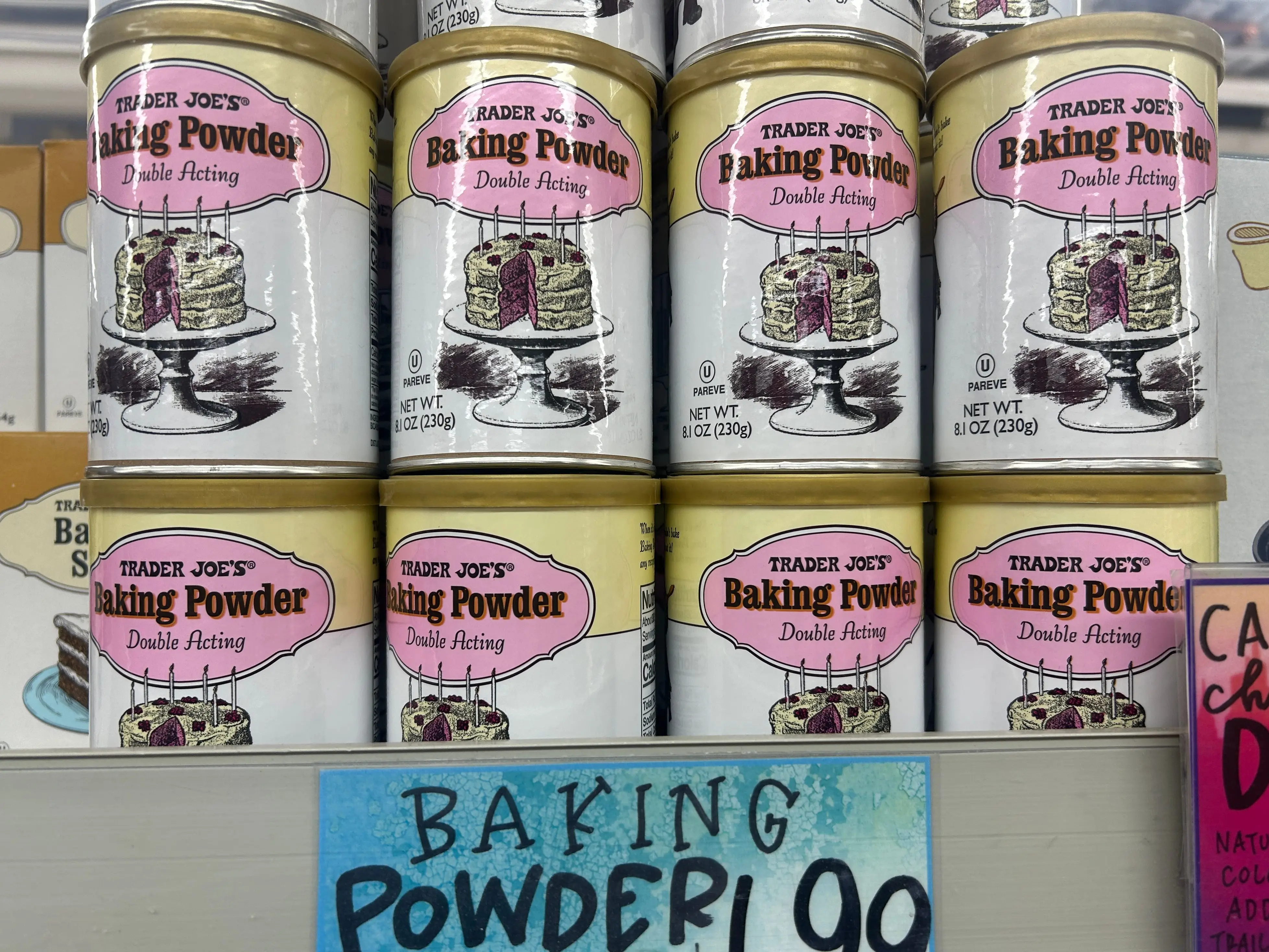 Several containers of Trader Joe's double-acting baking powder.