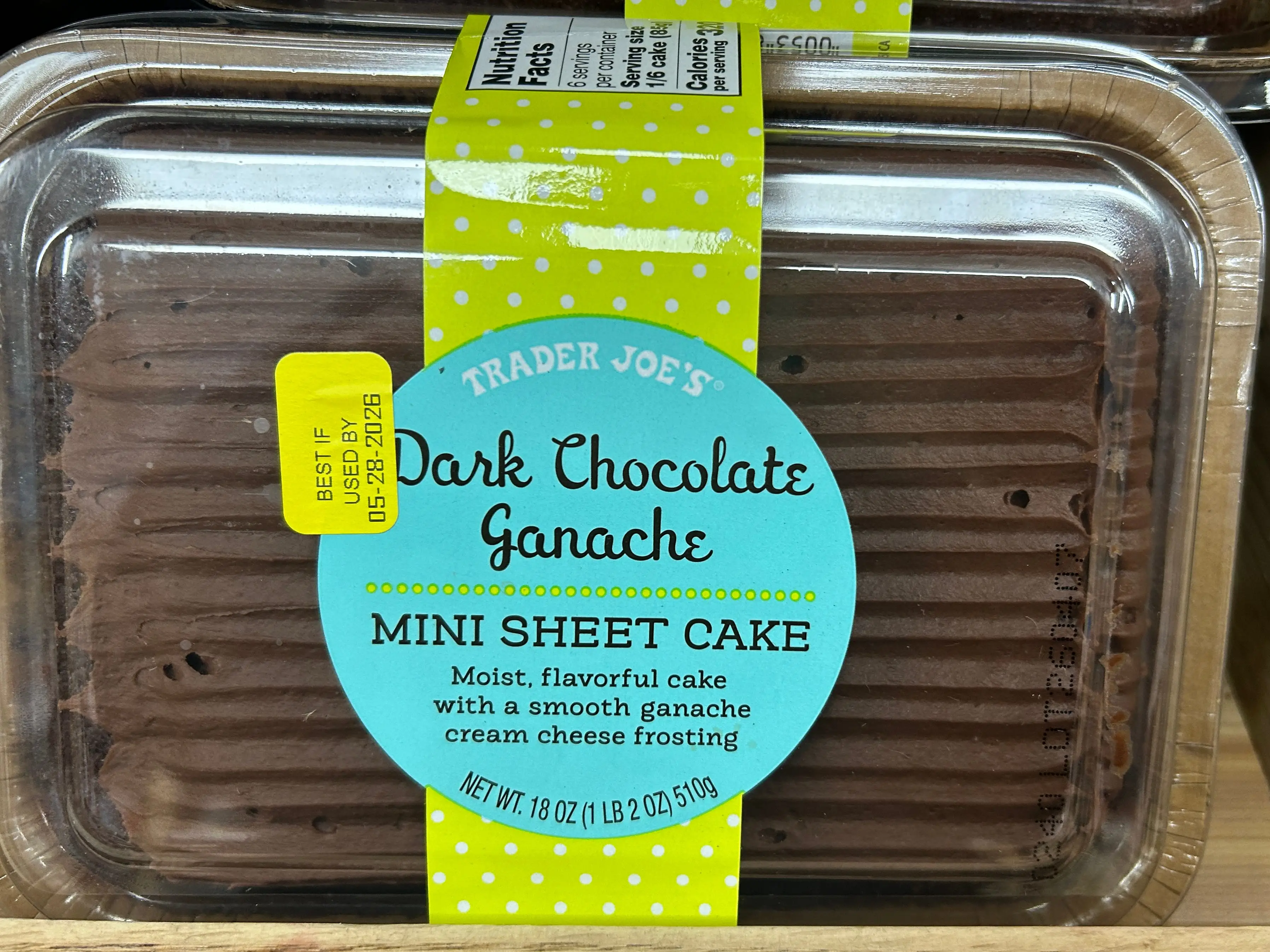 A Trader Joe's dark-chocolate-ganache mini sheet cake sits on a shelf.