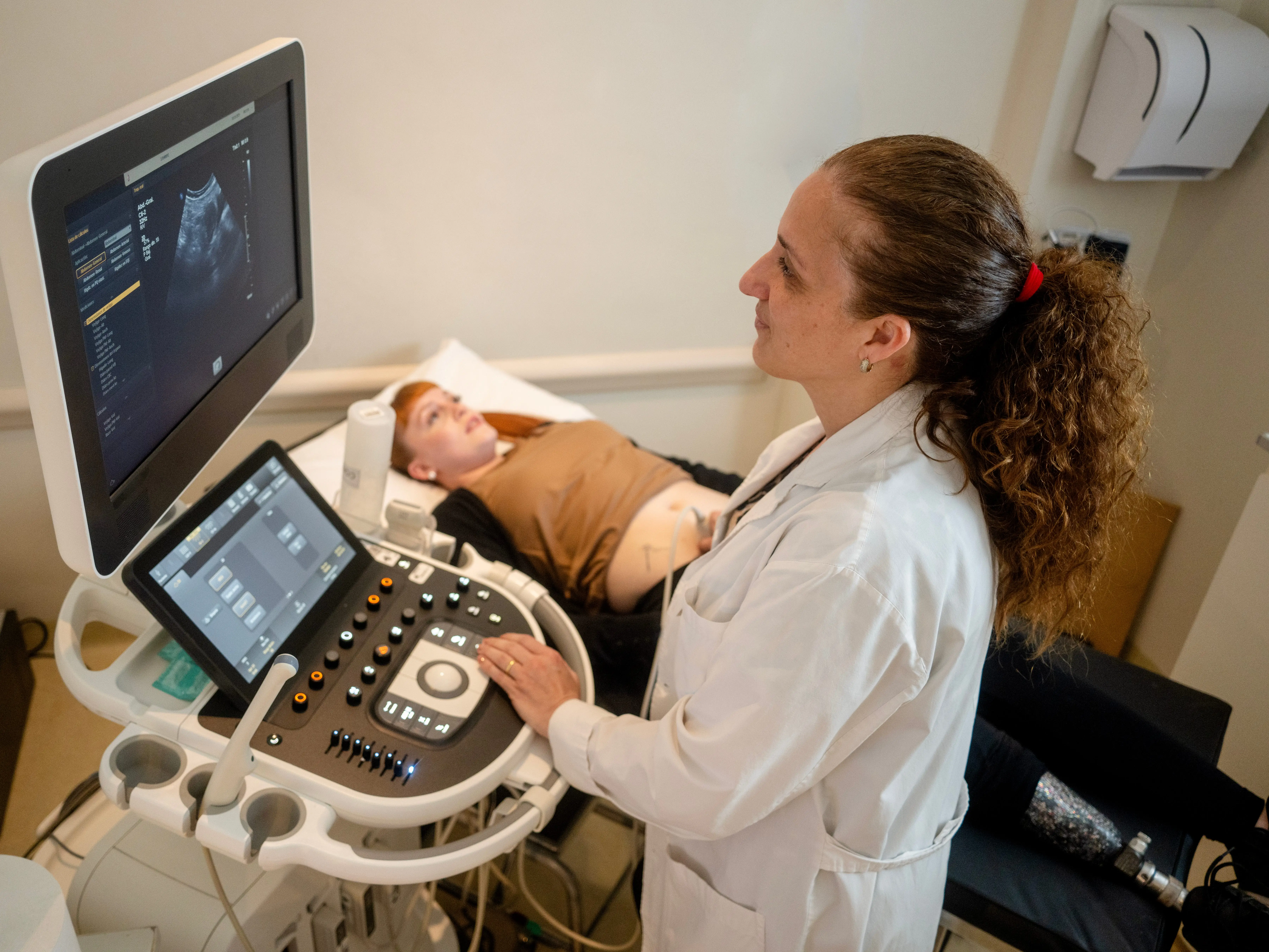 Healthcare worker performing an ultrasound on a patient