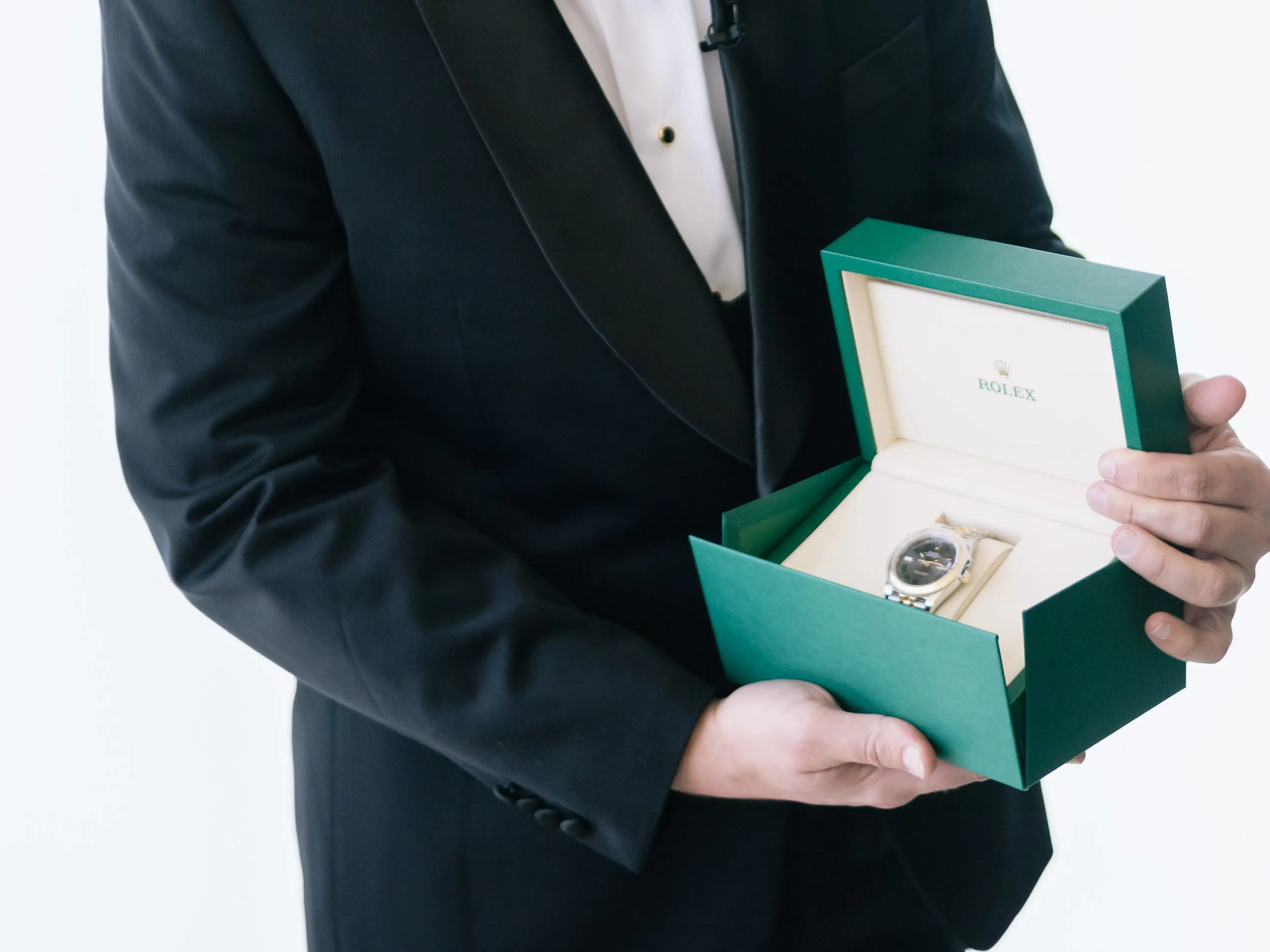 Christopher Kopinski looks at his Rolex.