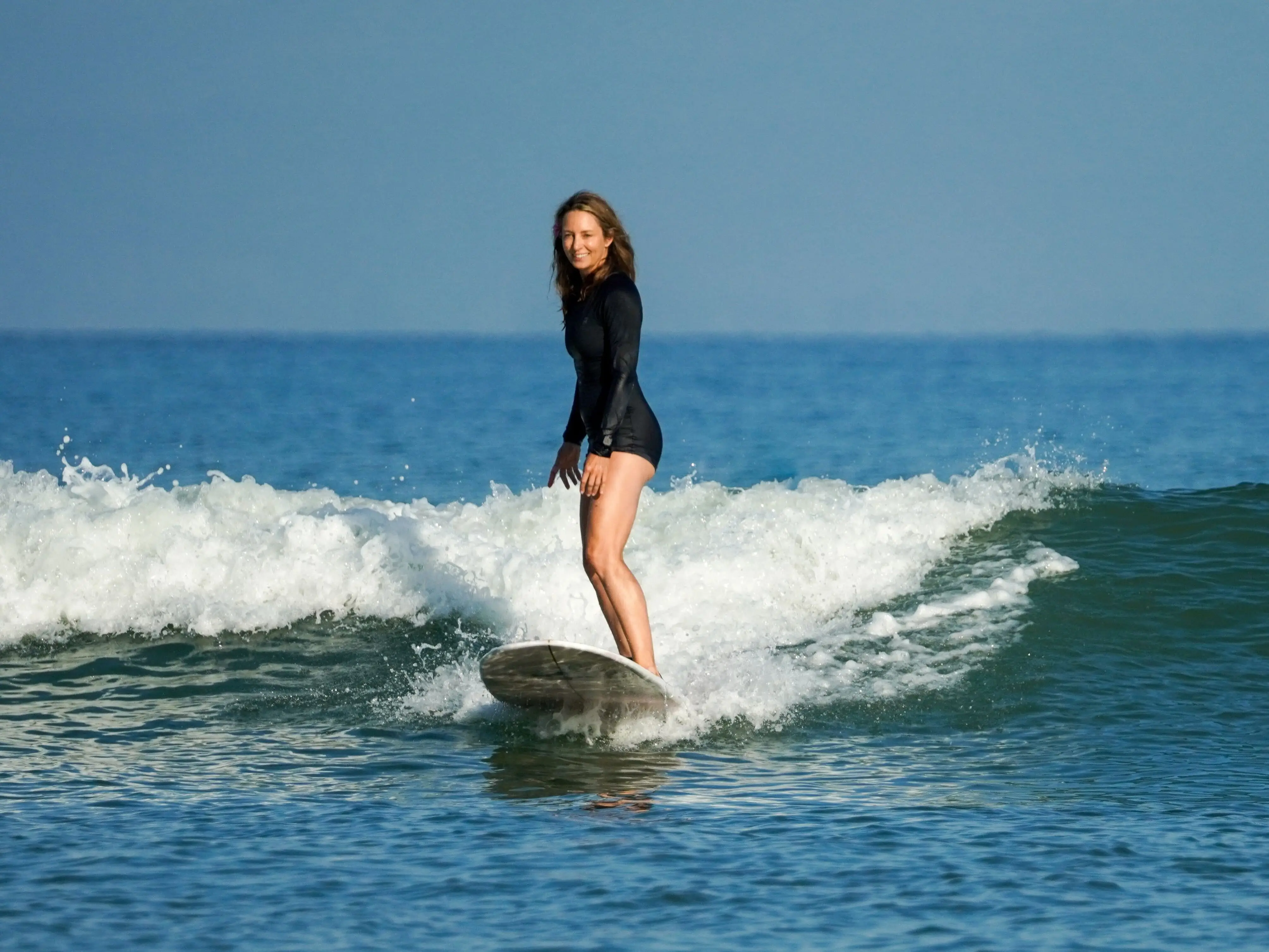Emily McCarthy, co-founder of GORUCK, surfing