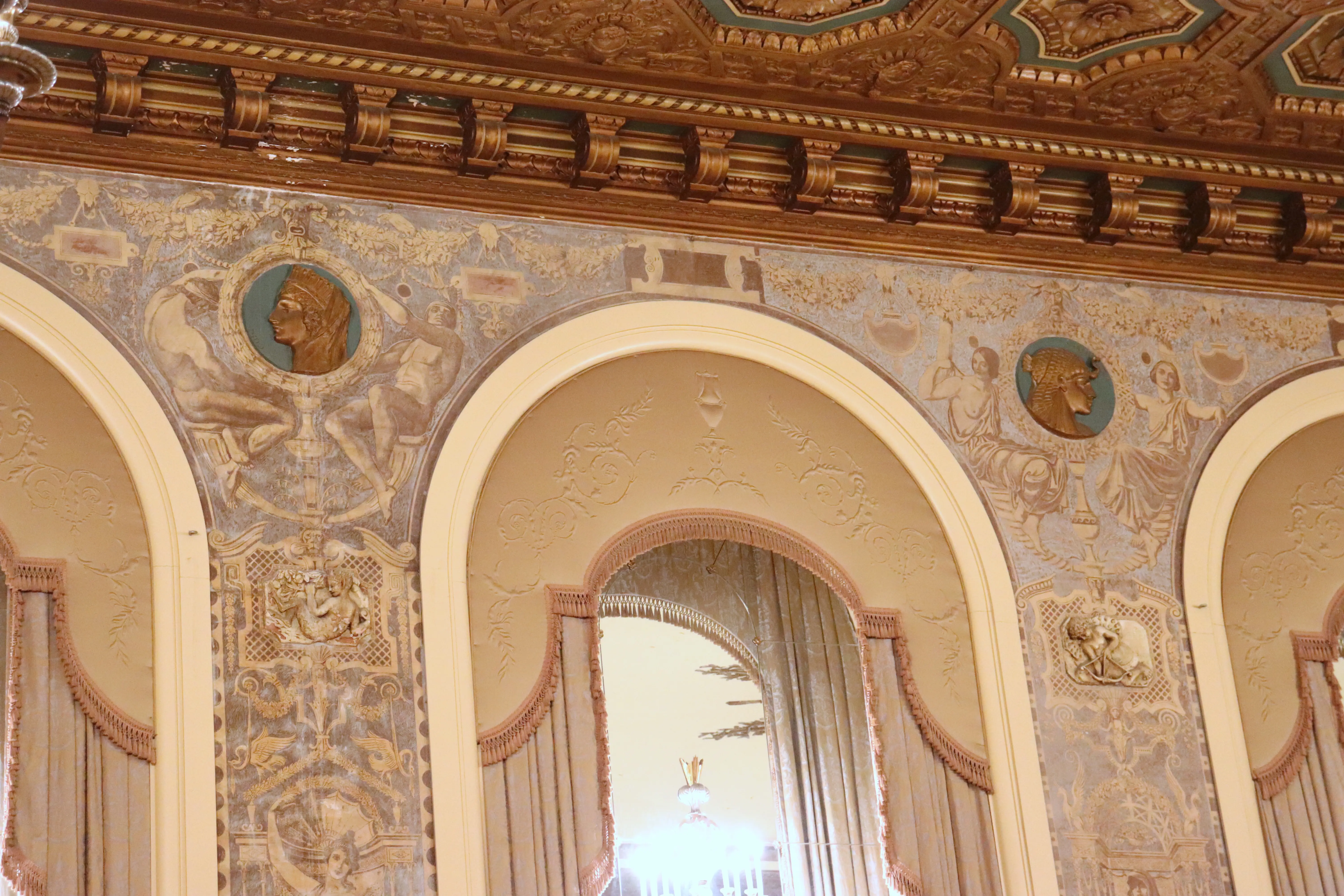 Medallions of historic women on the walls of the Gold Ballroom.