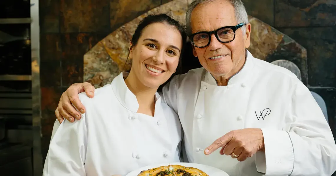I cooked with Wolfgang Puck at Spago. He showed me how to make his famous pizza.