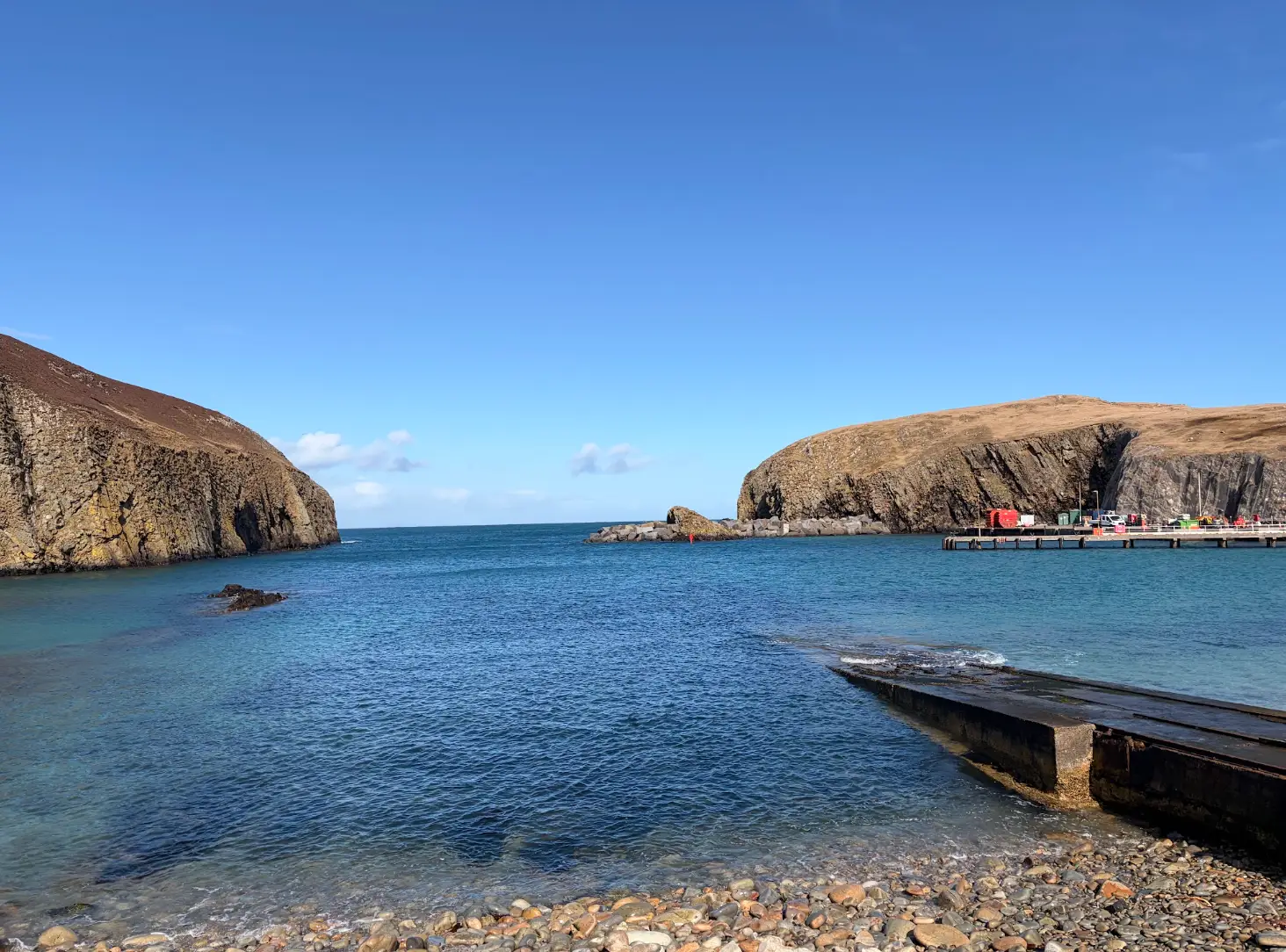 Blue water and cliffs near the writer's home in Fair Isle.