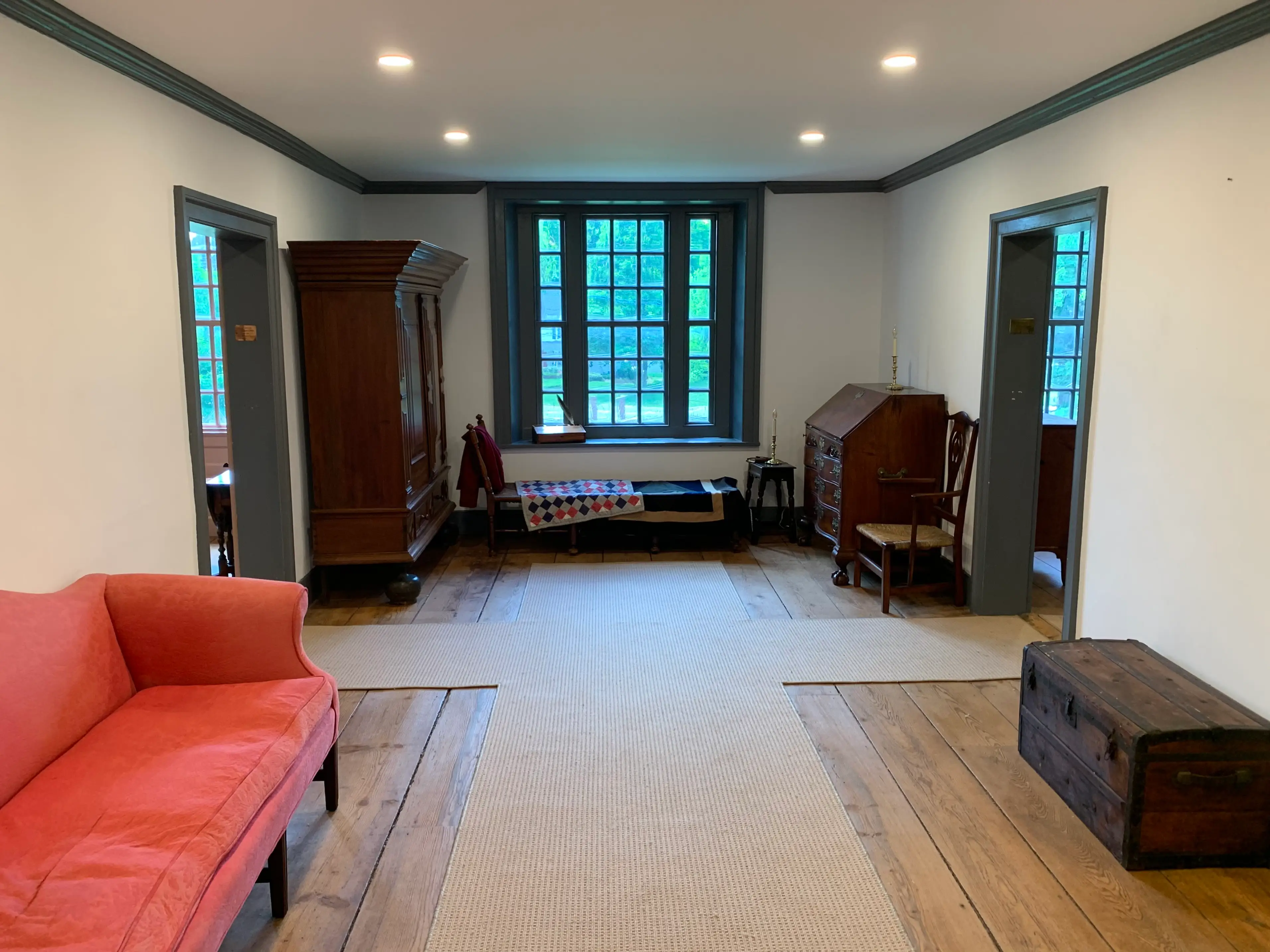 Upper hall of the Dey mansion with a couch and dressers