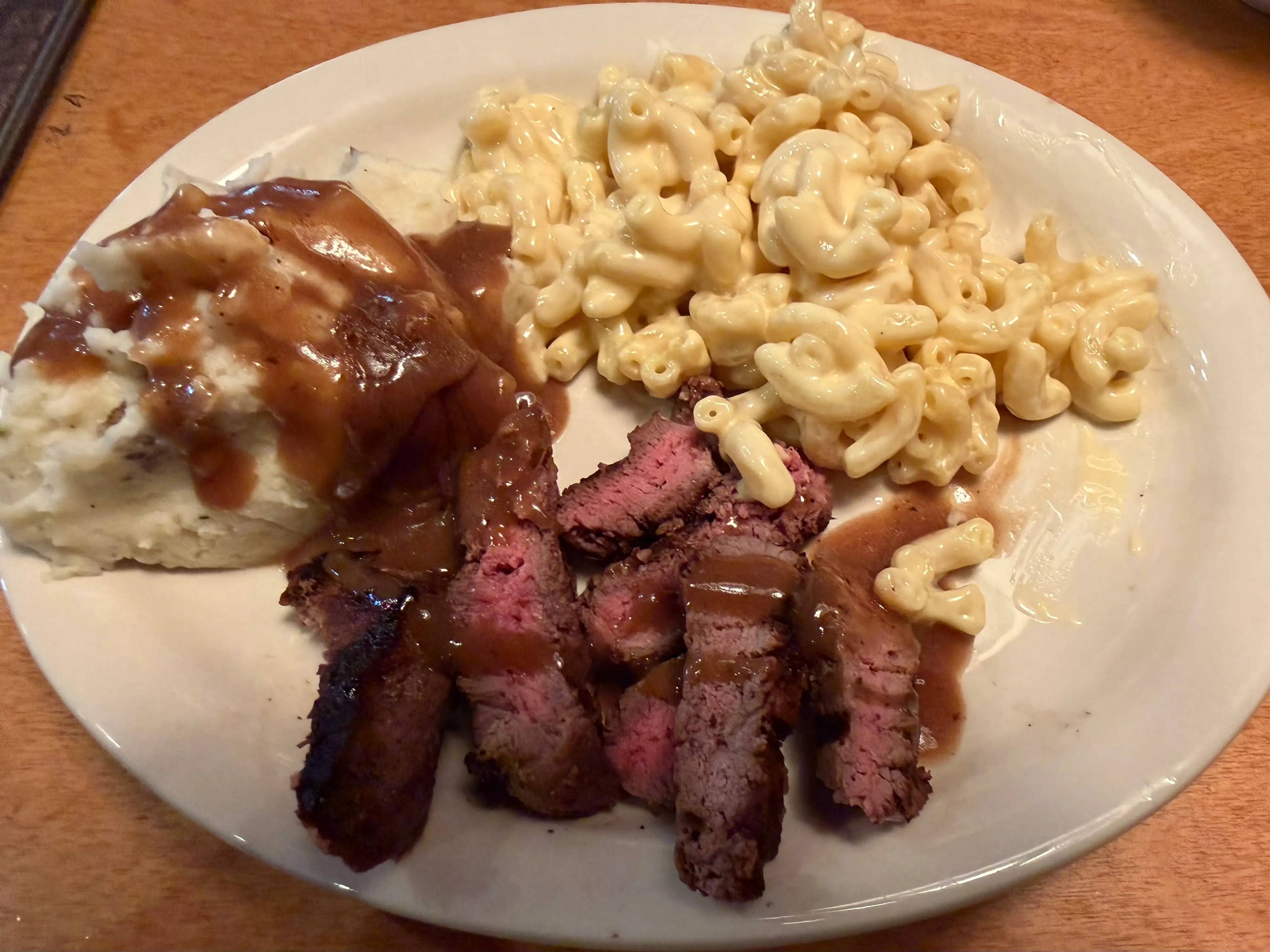 plate of mac and cheese, mashed potatoes with gravy, and steak at Texas Roadhouse