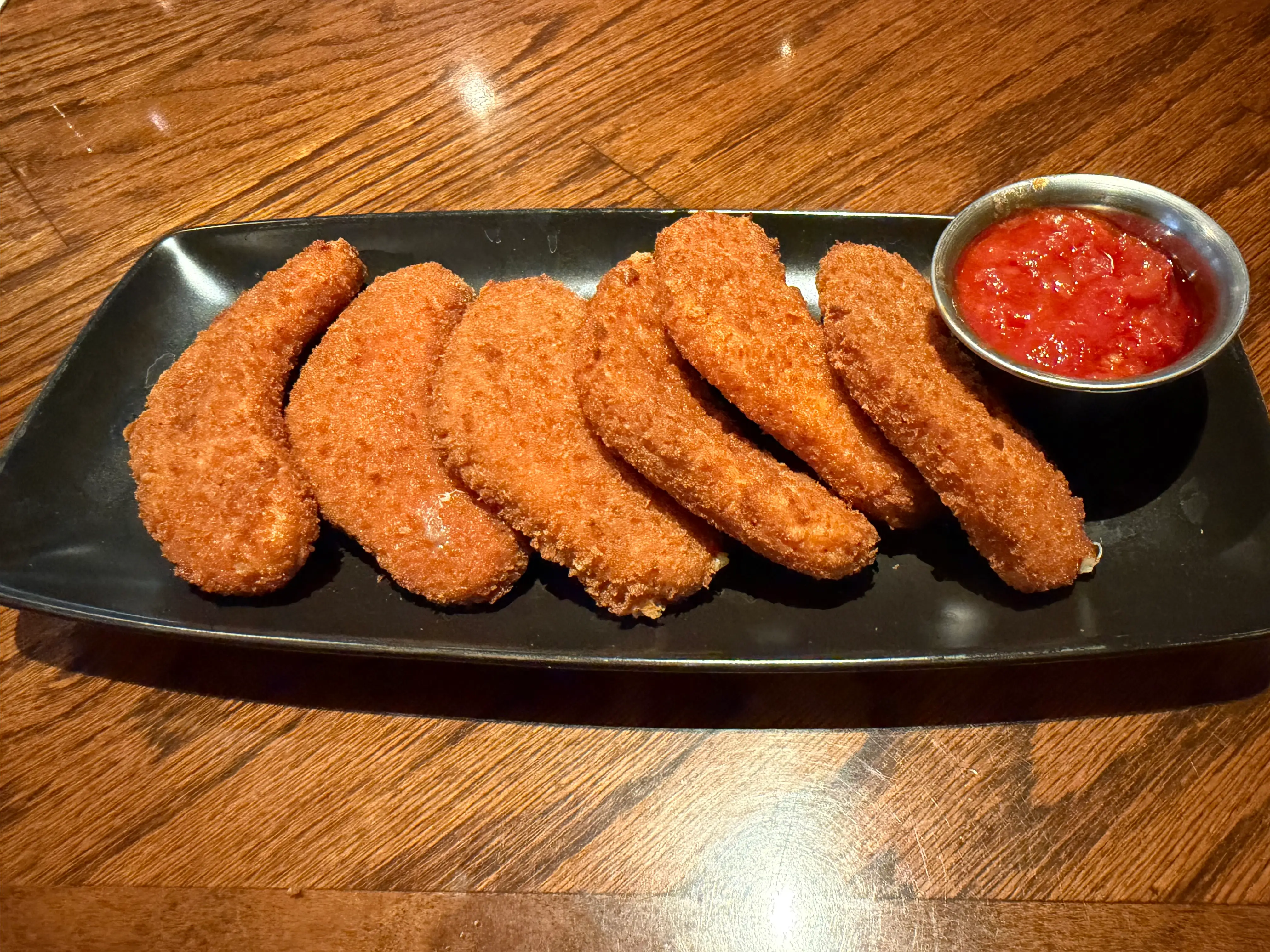 fried mozarella boomerangs with side of marinara at Outback Steakhouse