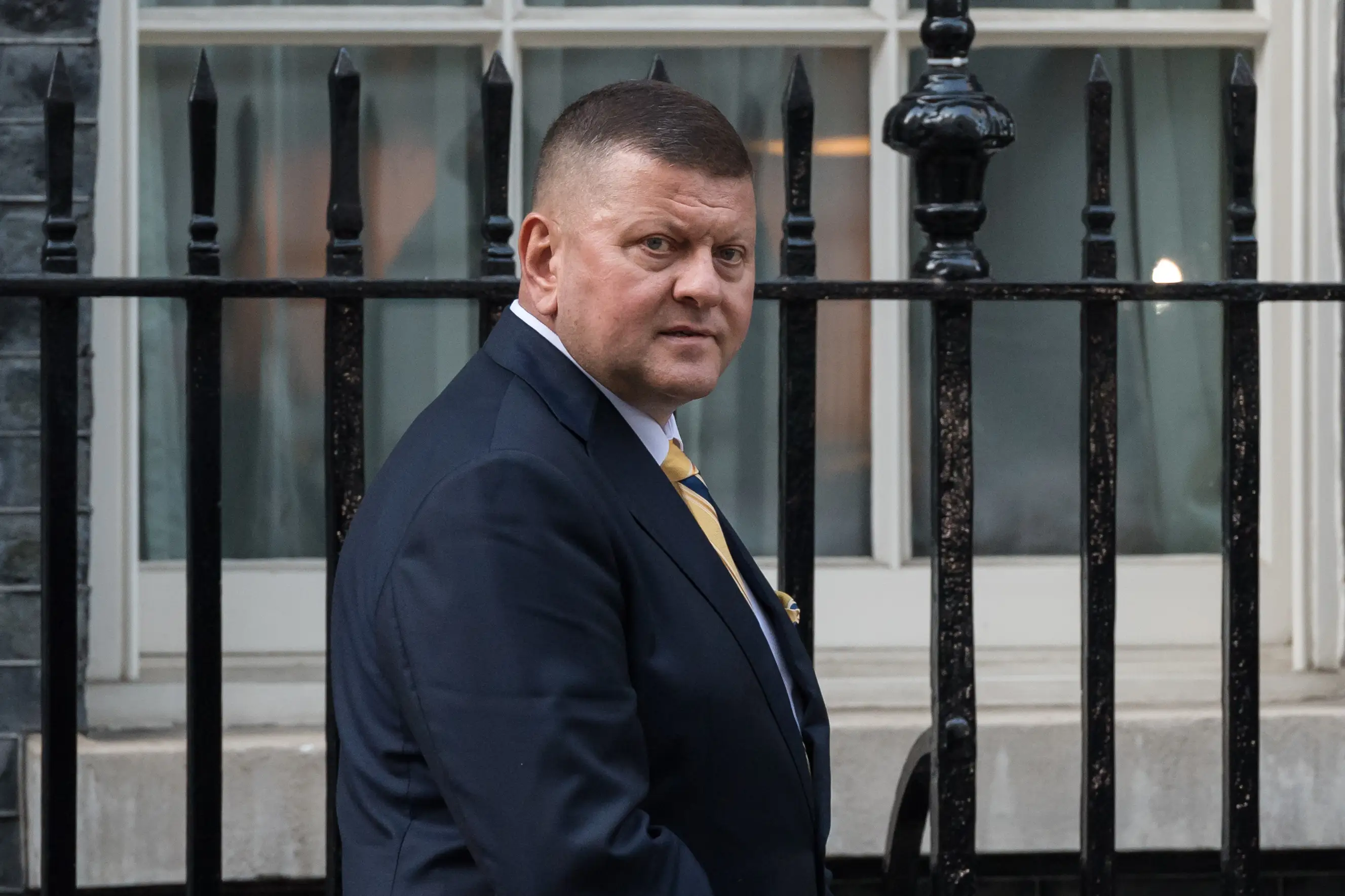 Valerii Zaluzhnyi, now Ukraine's ambassador to the UK, walks near a fence on Downing Street.