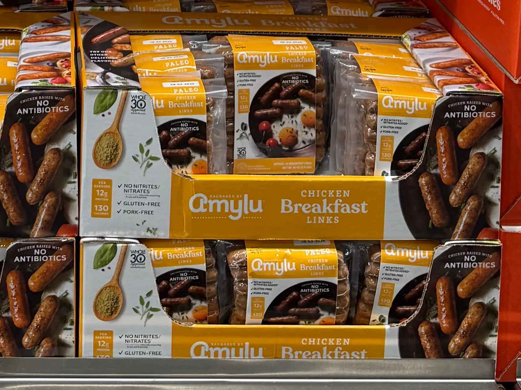 Multiple packages of Amylu chicken breakfast sausage links.