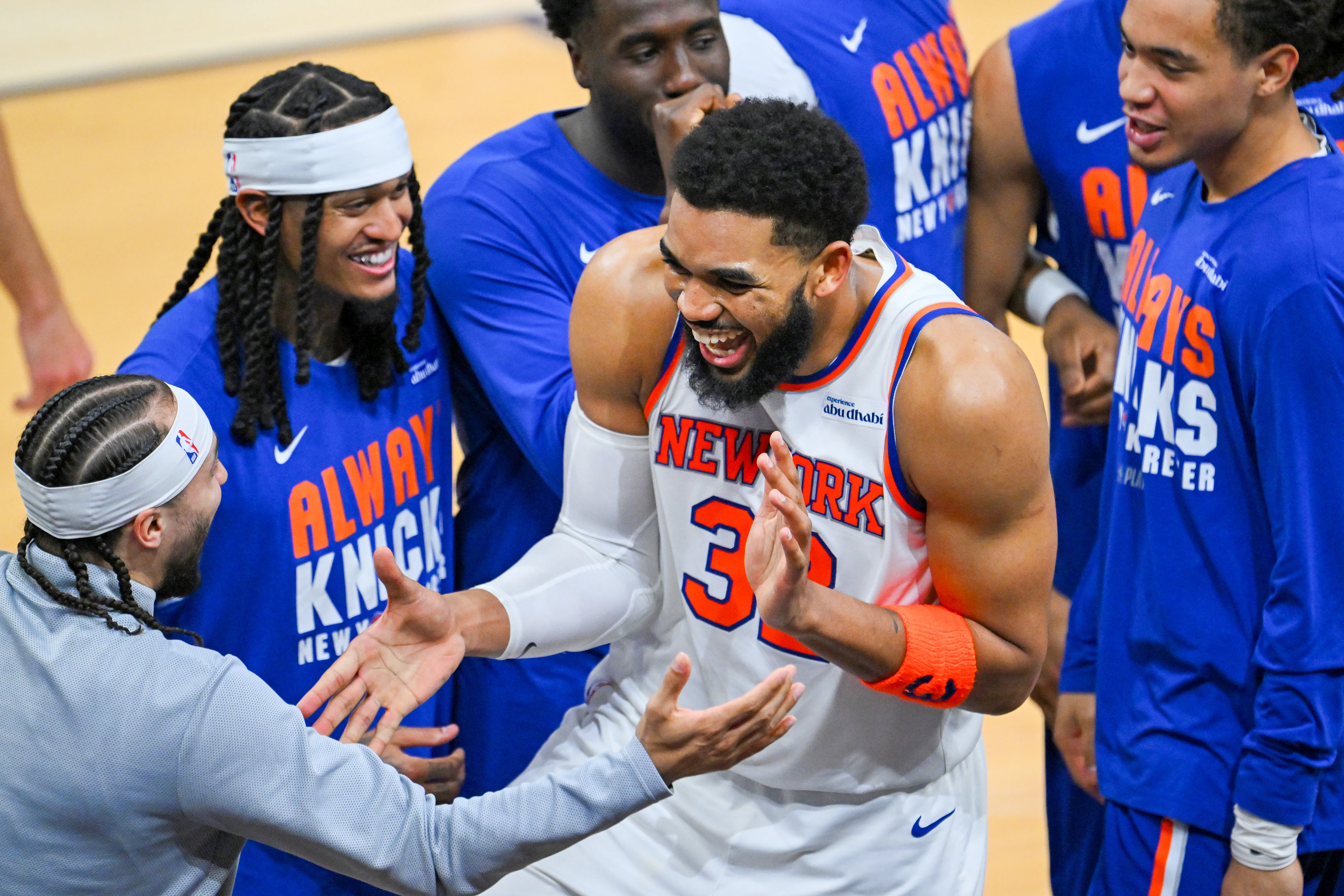 New York Knicks center Karl-Anthony Towns celebrates with his teammates.