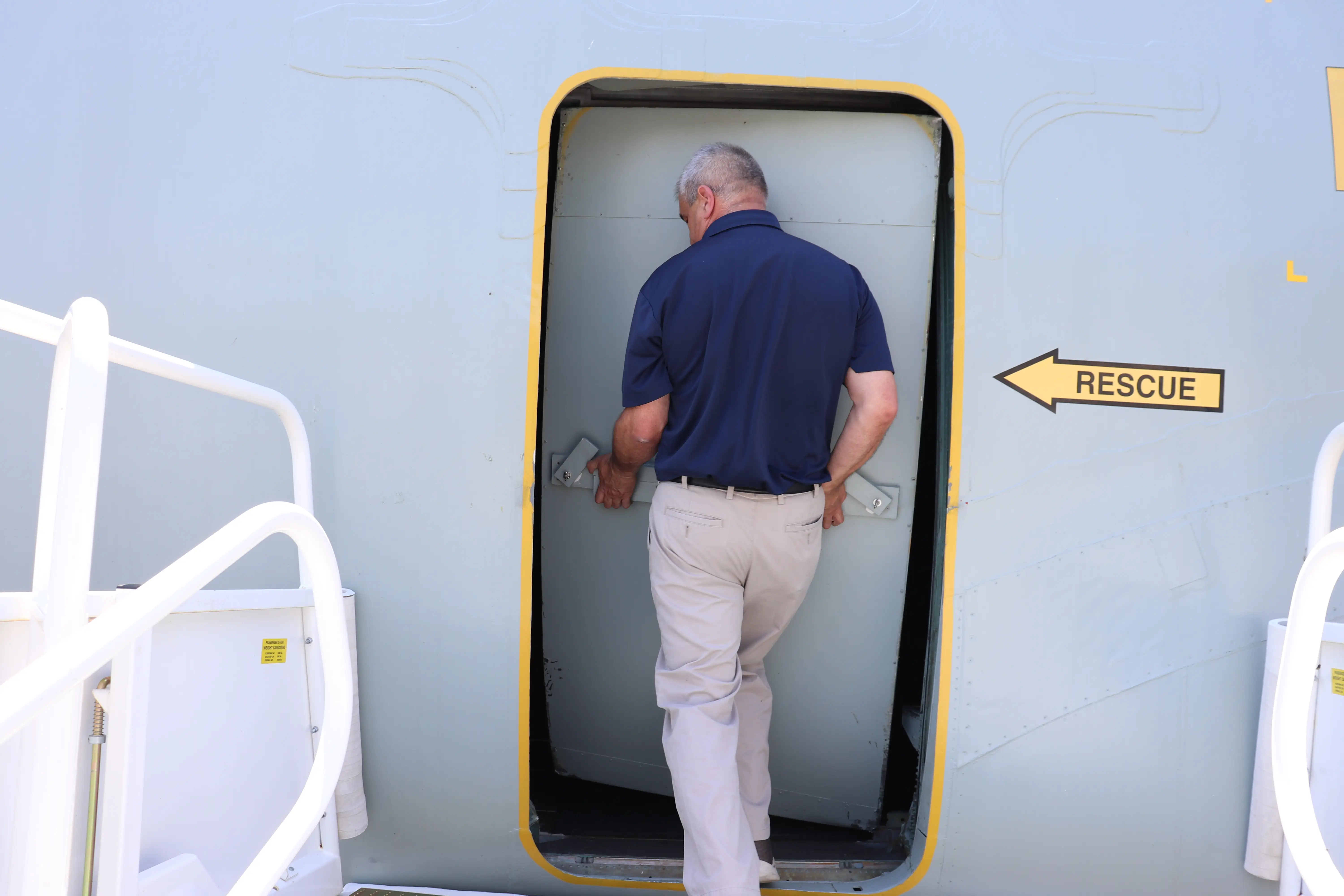 Air Mobility Command Museum operations manager Michael Hurlburt opens the C-5A Galaxy.