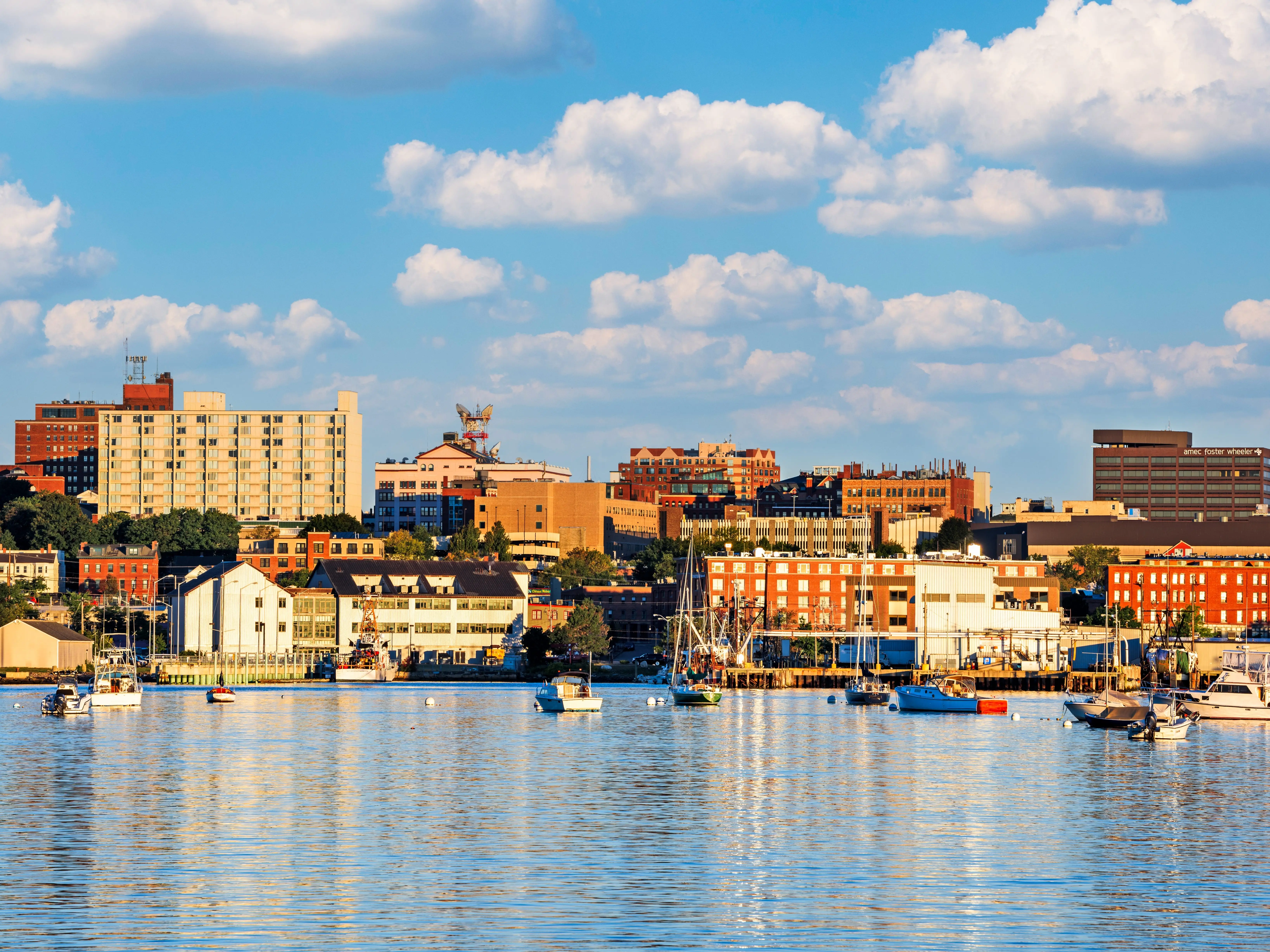 Buildings next to boats on the water in Portland, Maine.
