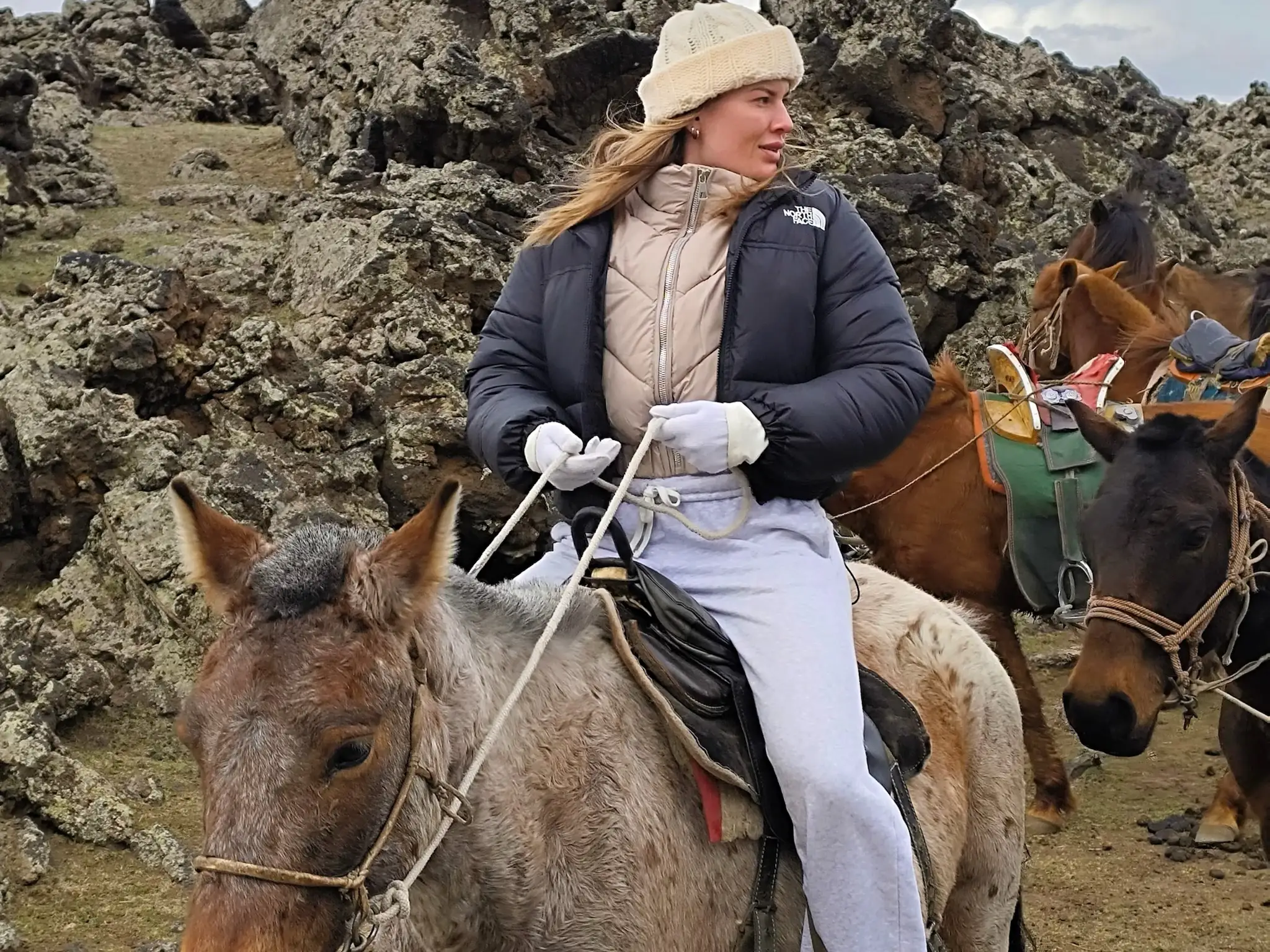 A woman riding a donkey in Mongolia's Gobi Desert.